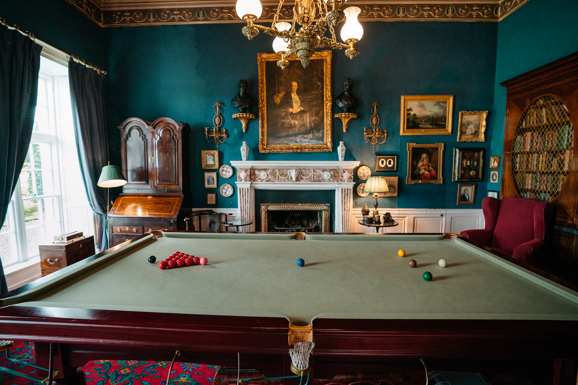 A room with a fireplace and a table with balls on it