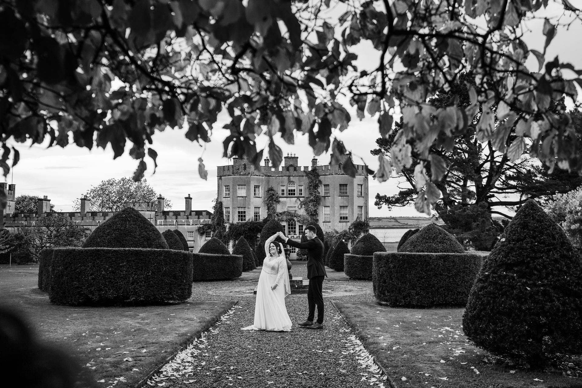 A man and woman kissing in a garden