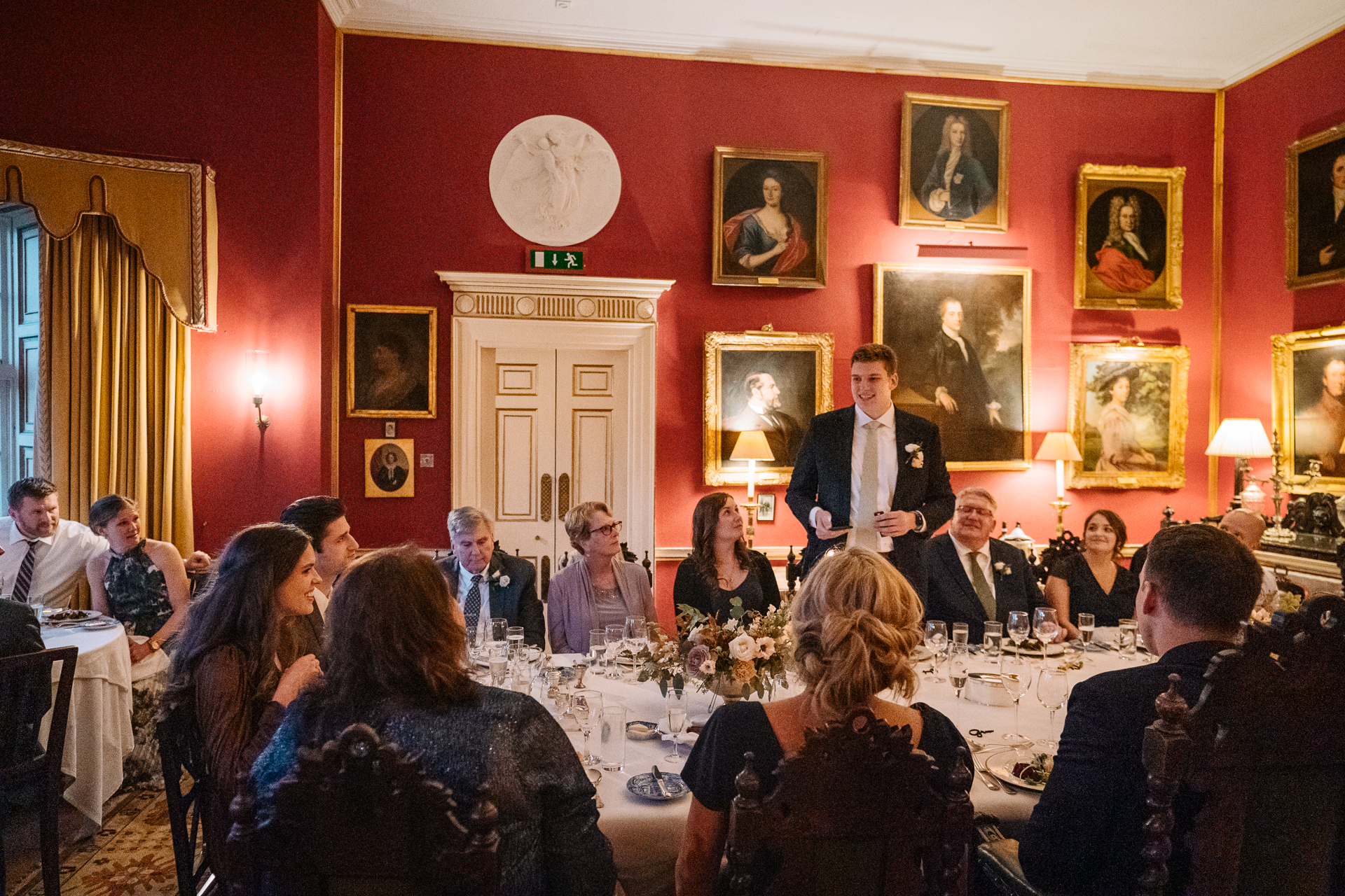 A person speaking to a group of people in a room