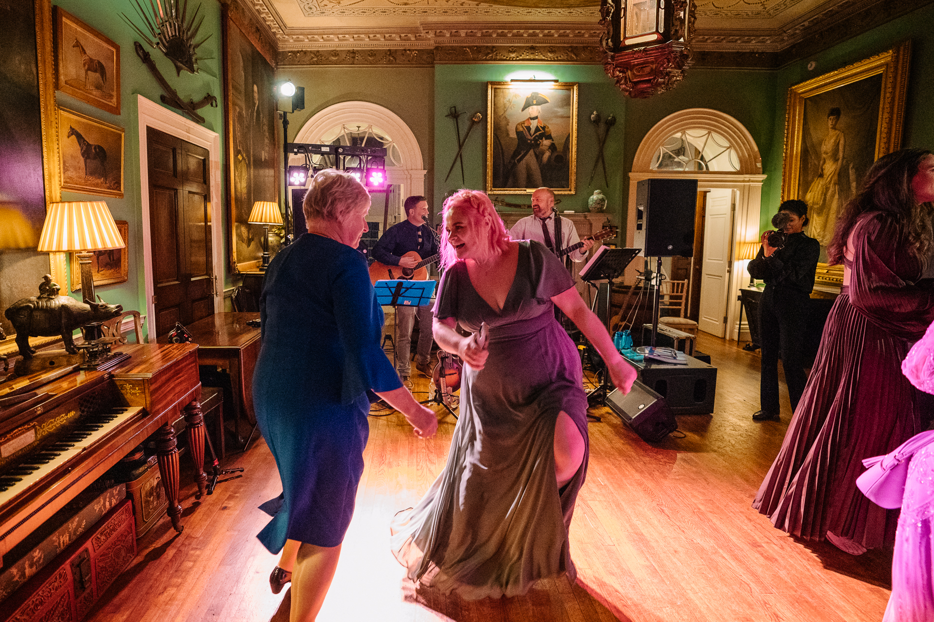 A group of people dancing in a room with a piano