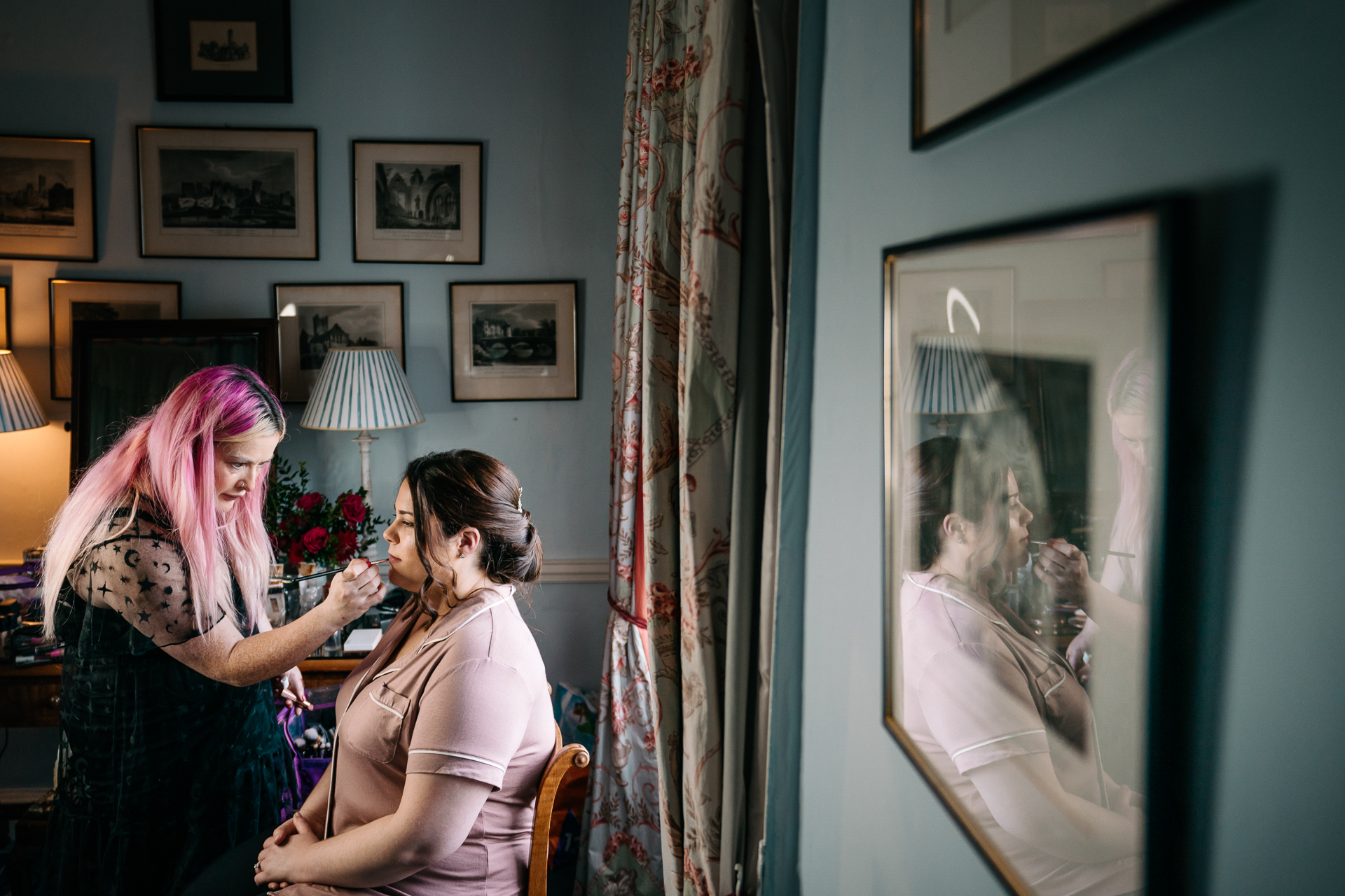 A woman looking at a picture on the wall