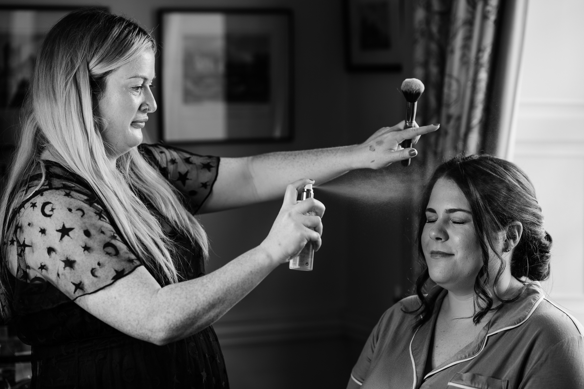 A woman holding a hammer to a woman's head