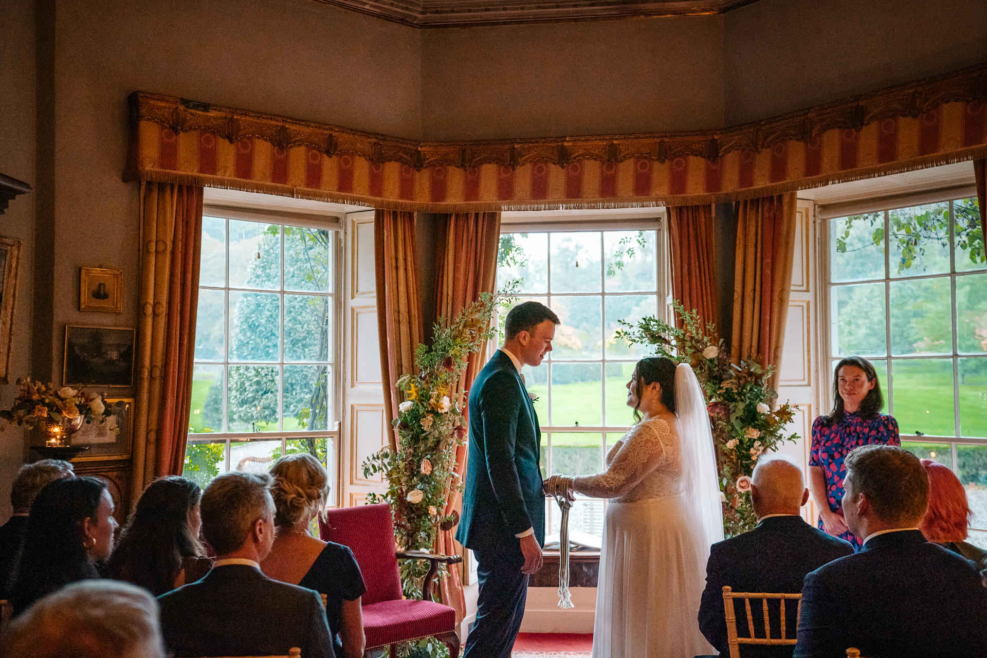 A man and woman dancing in a room with a crowd watching