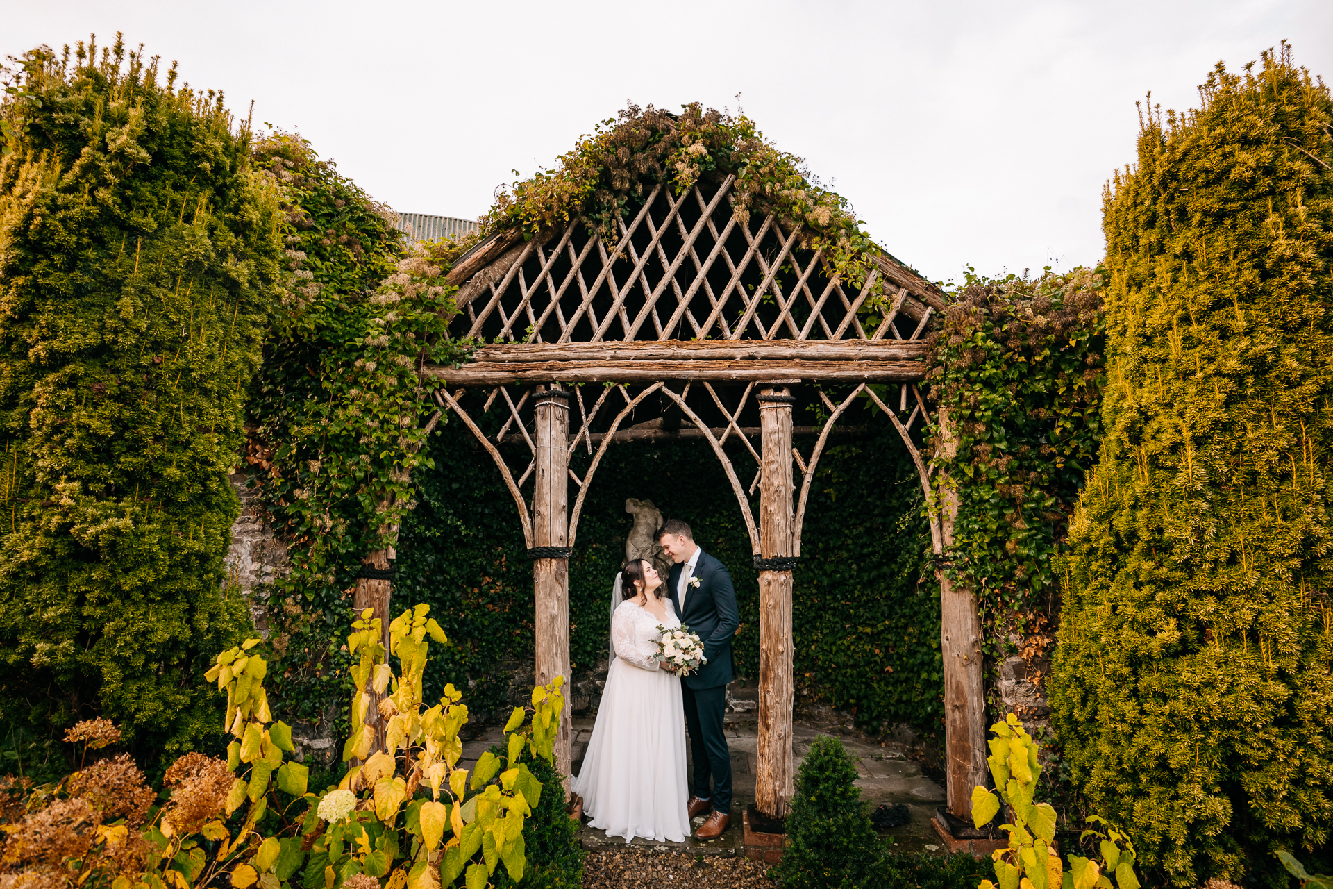 A man and woman posing for a picture in front of a gazebo