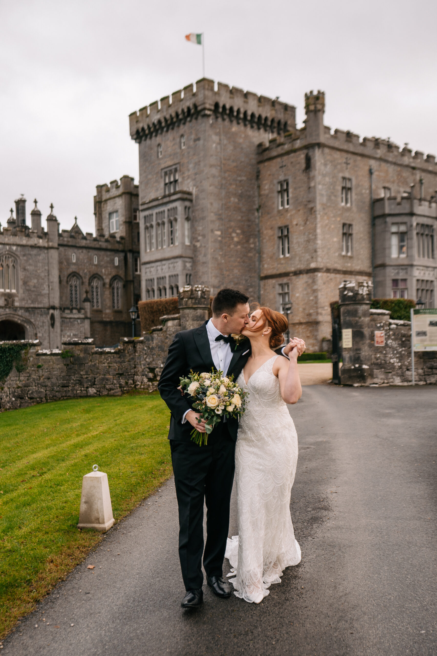 A man and woman posing for a picture in front of a castle