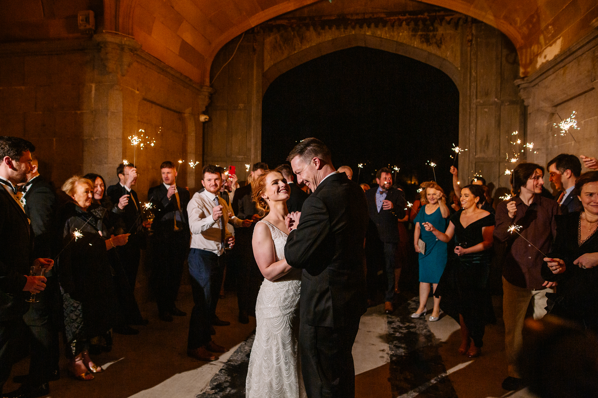 A man and woman dancing in a room full of people