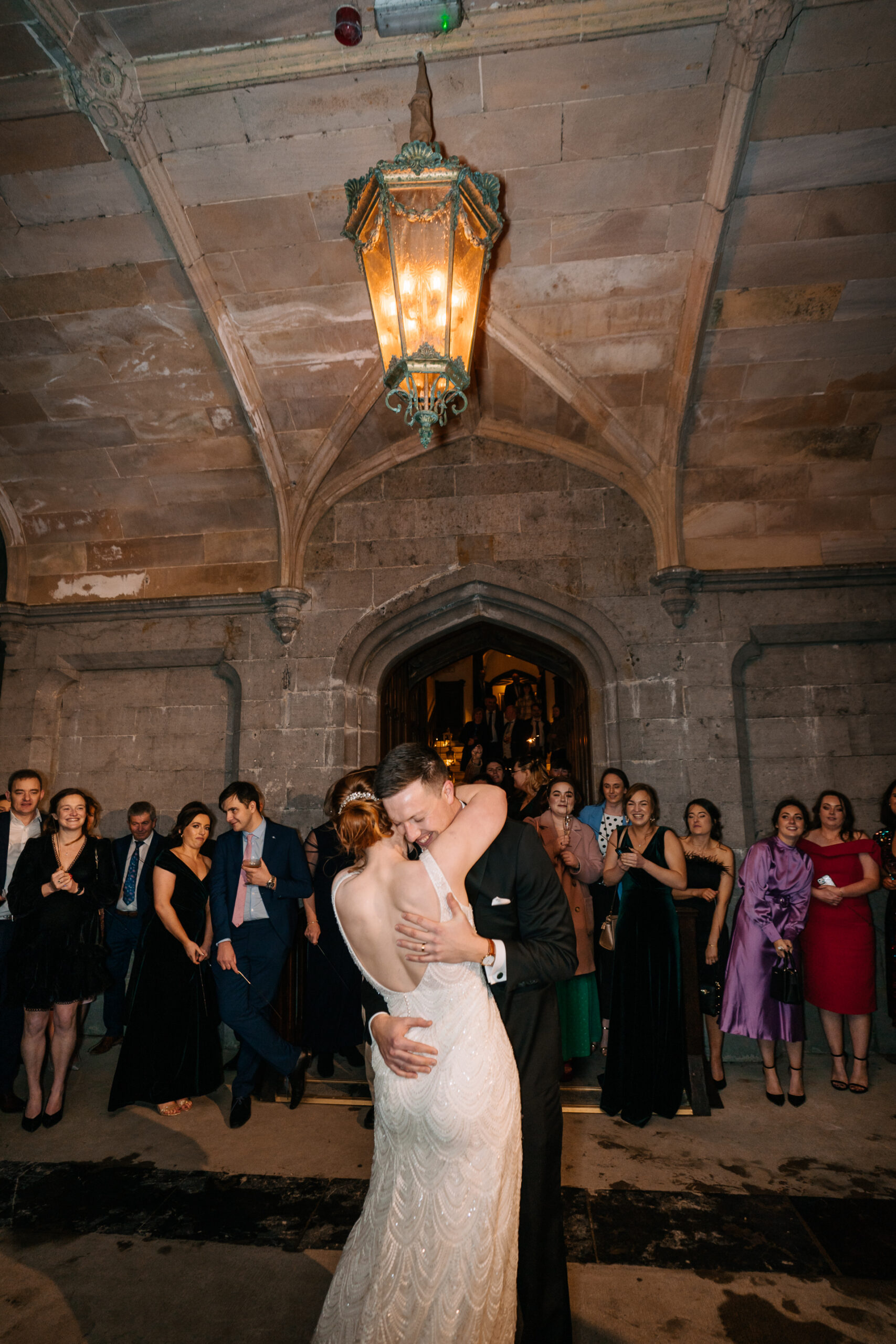 A man and woman kissing in front of a group of people