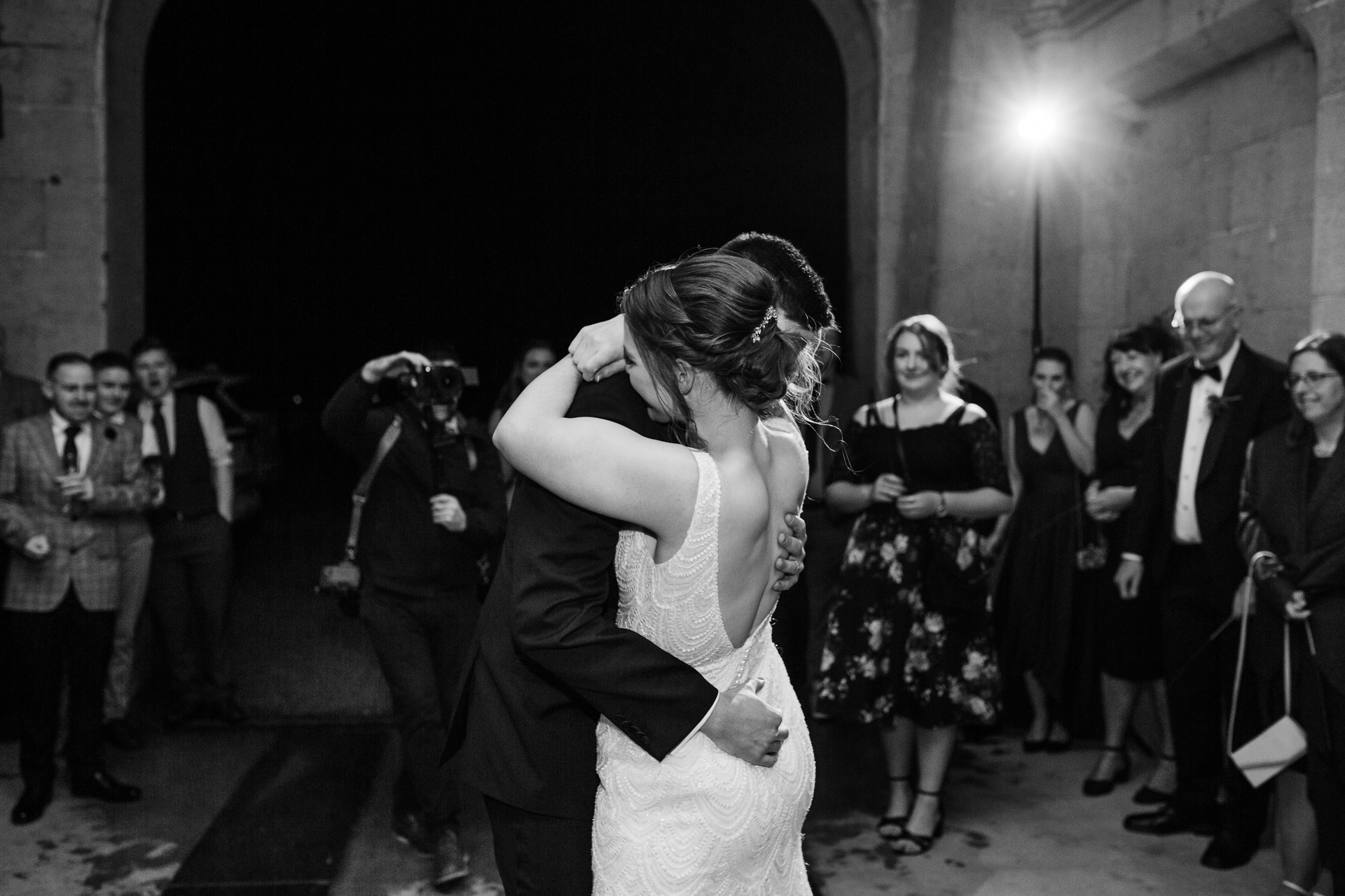 A woman in a dress kissing a man in a tuxedo