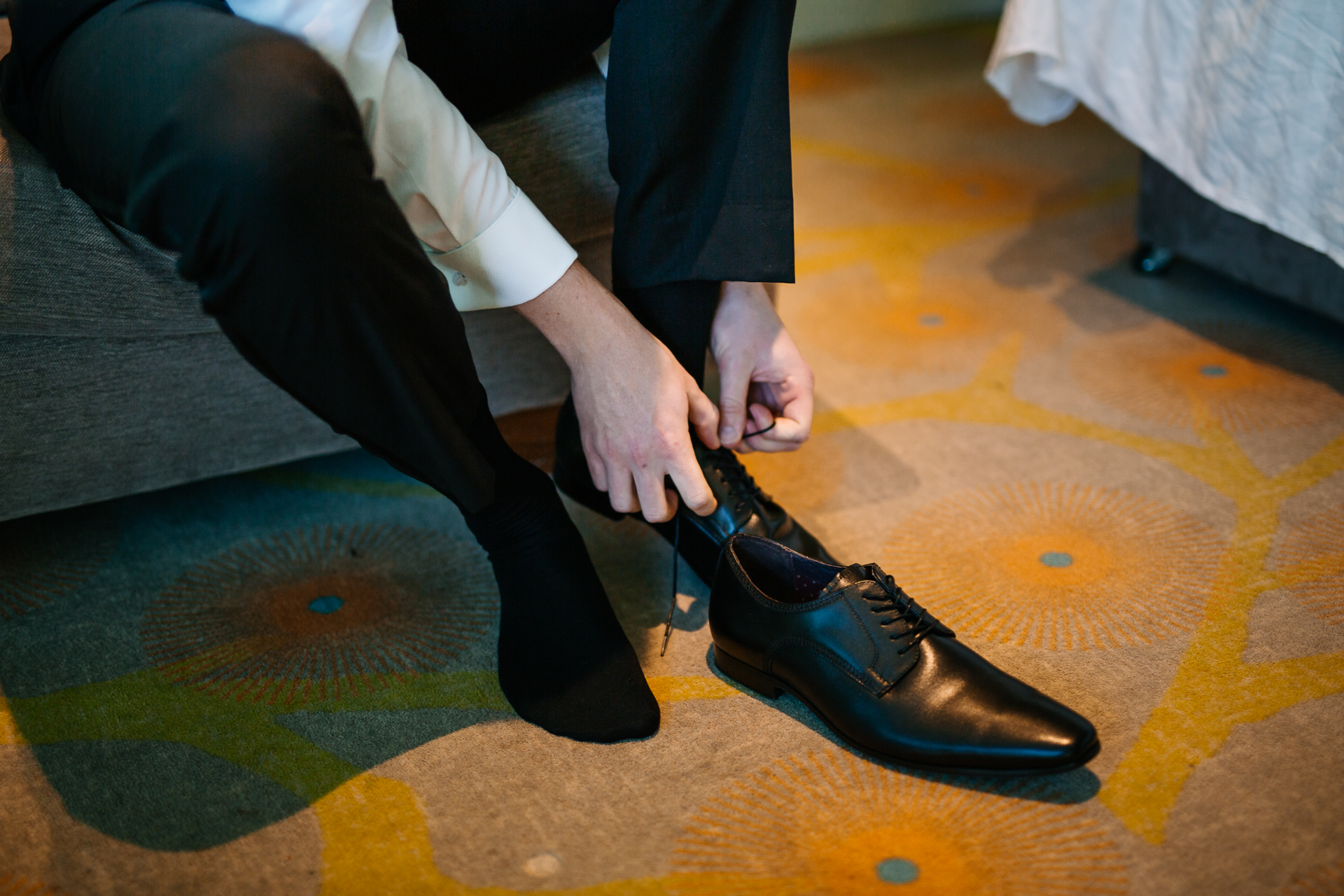 A person's feet on a yellow and black floor