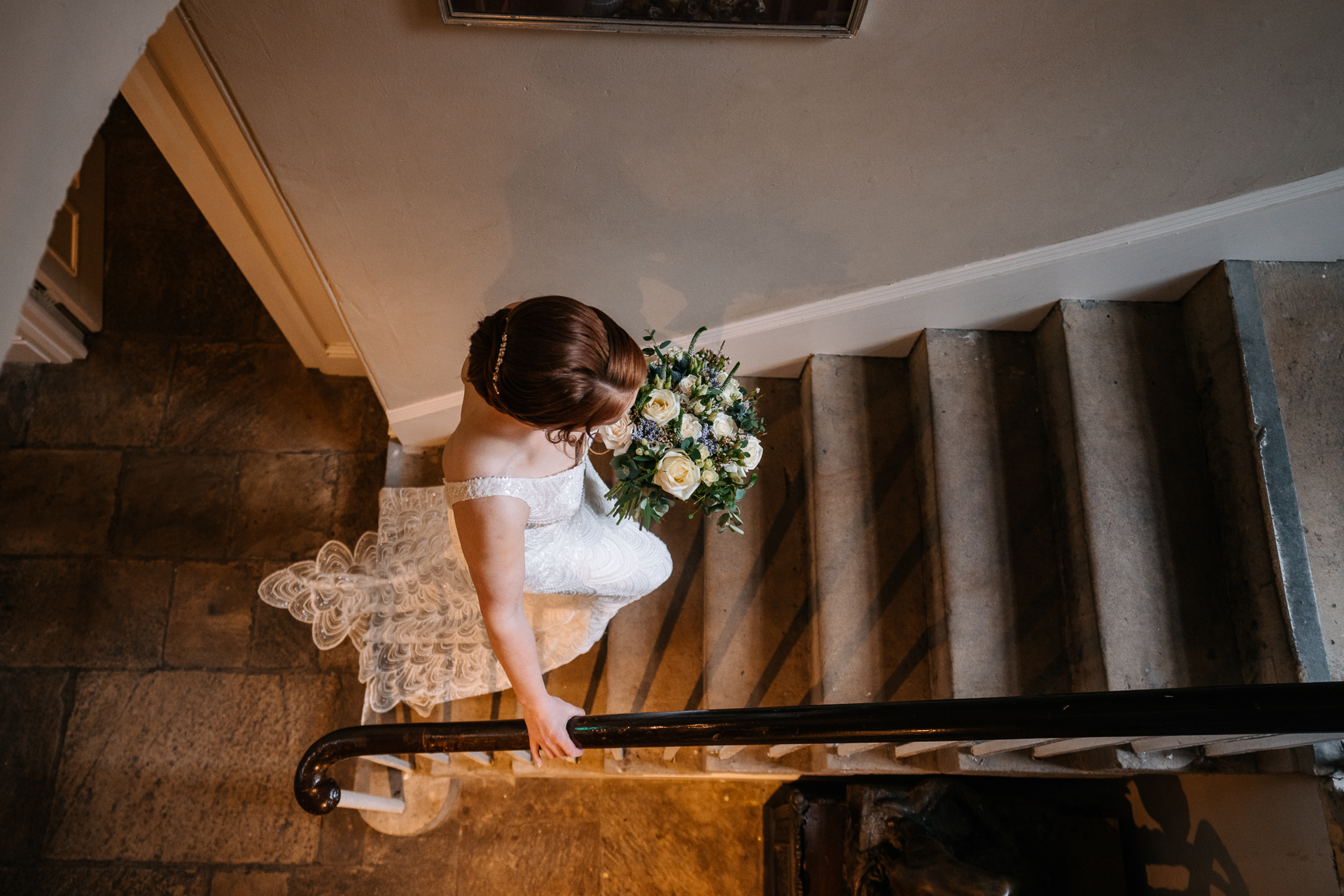 A person in a wedding dress sitting on a staircase