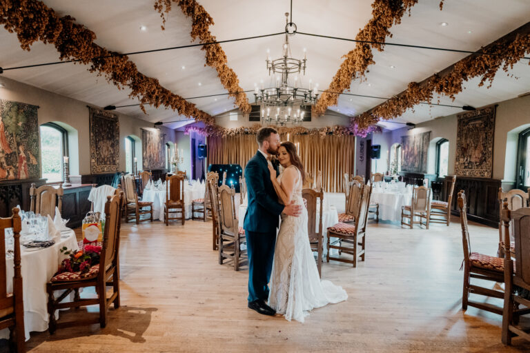 Bride and groom share their first dance in the elegant reception hall of Barberstown Castle.