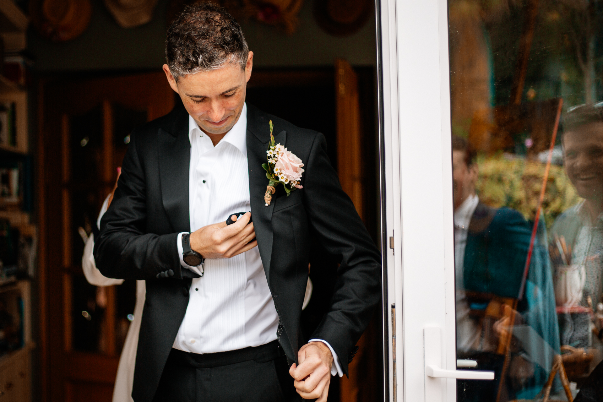 A person in a suit holding a flower