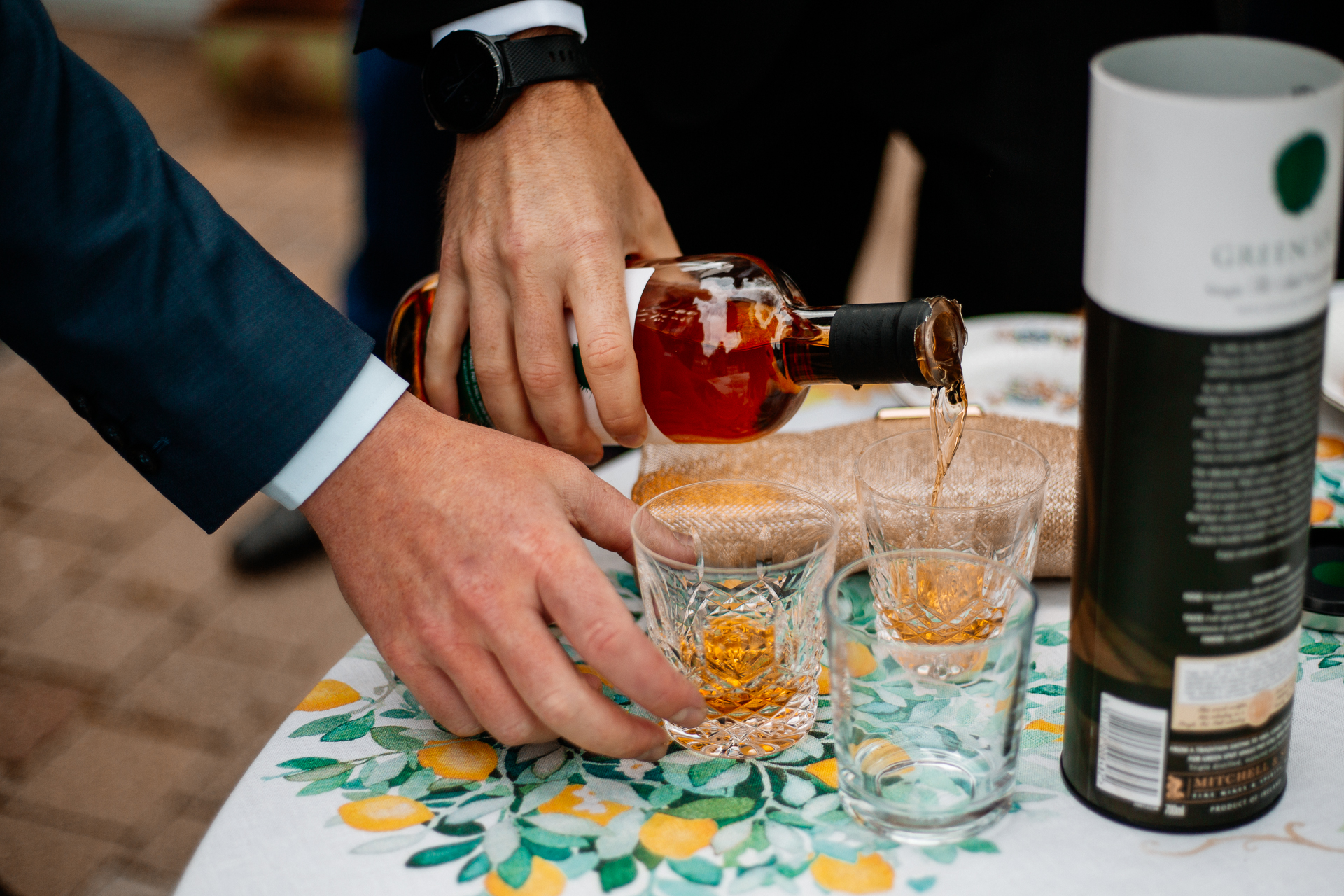 A person pouring liquid into glasses