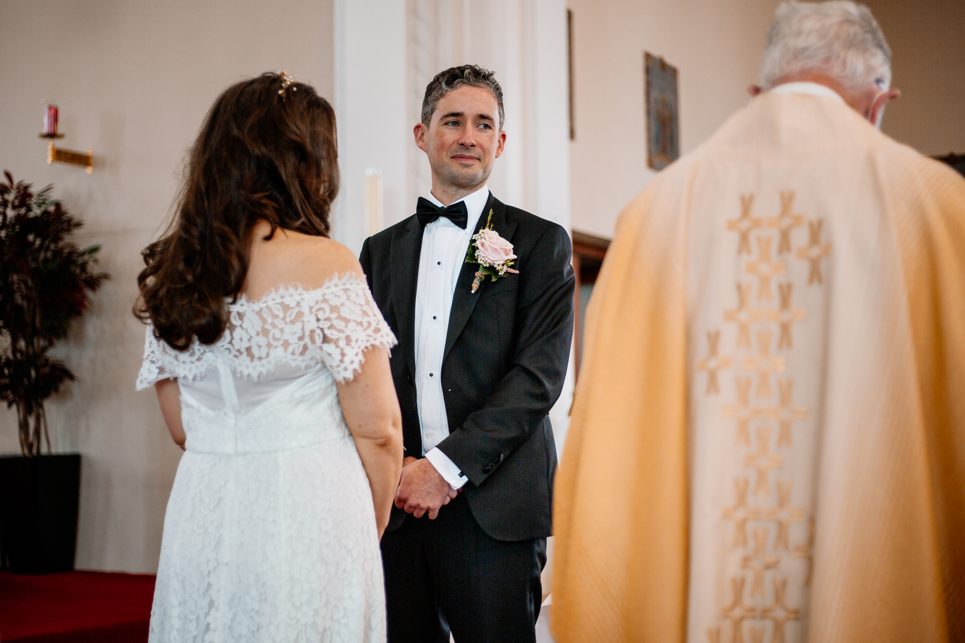 A man in a tuxedo and a woman in a white dress