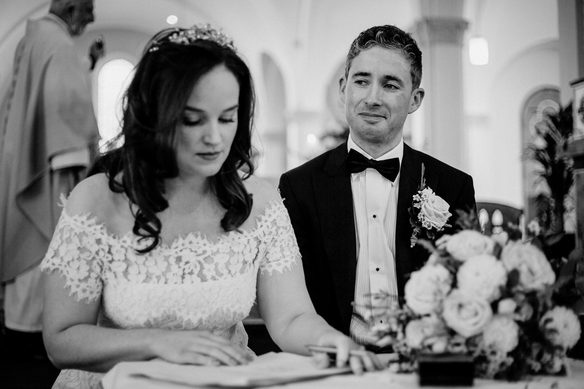 A man and woman sitting at a table with flowers