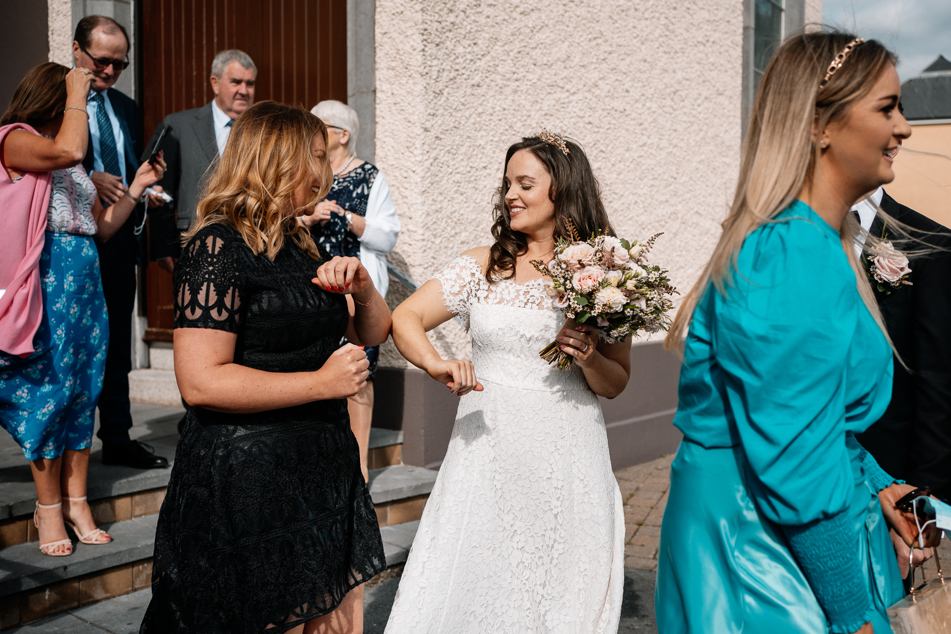 A person in a white dress holding a bouquet of flowers