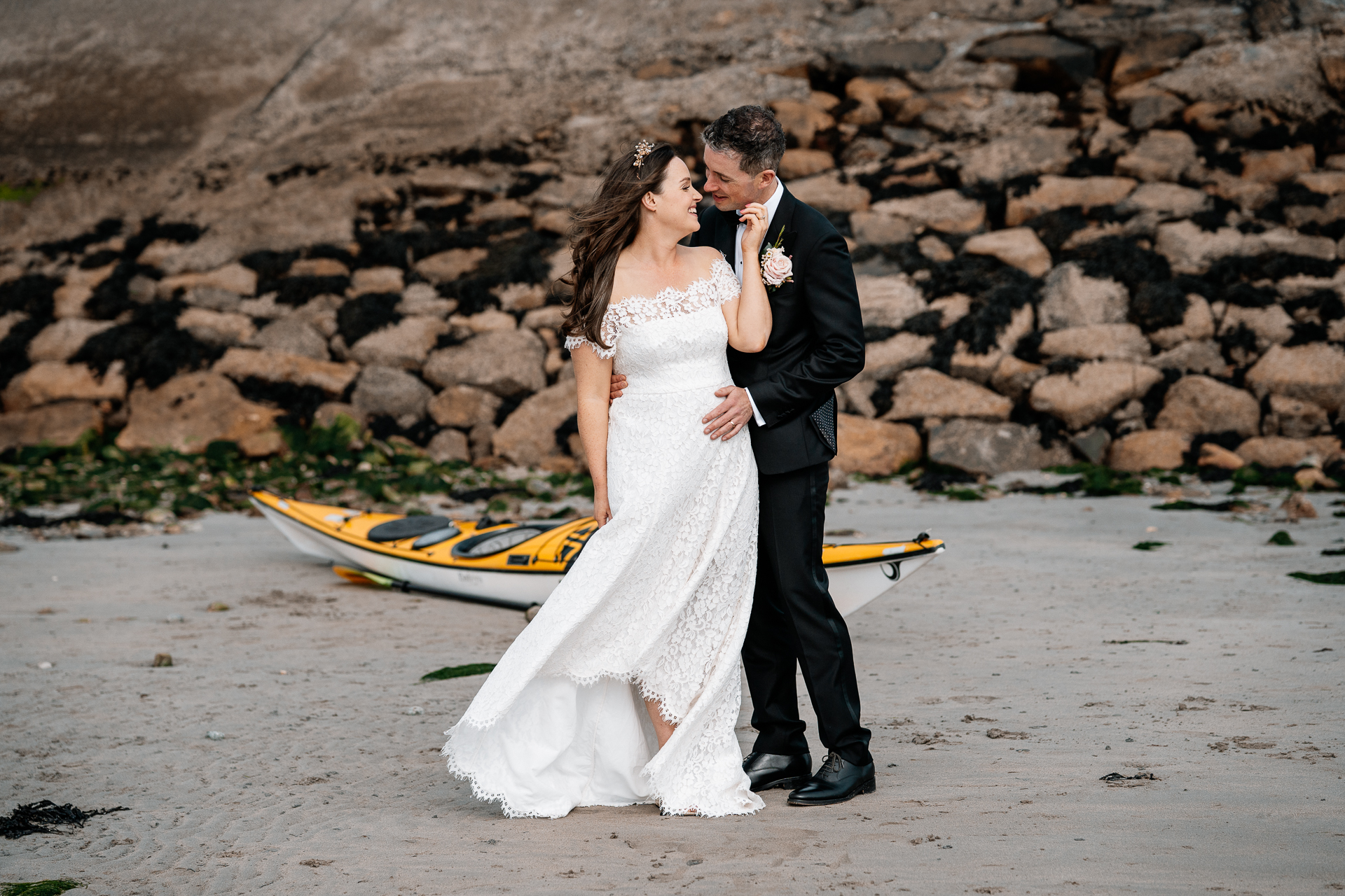 A man and woman kissing on a beach