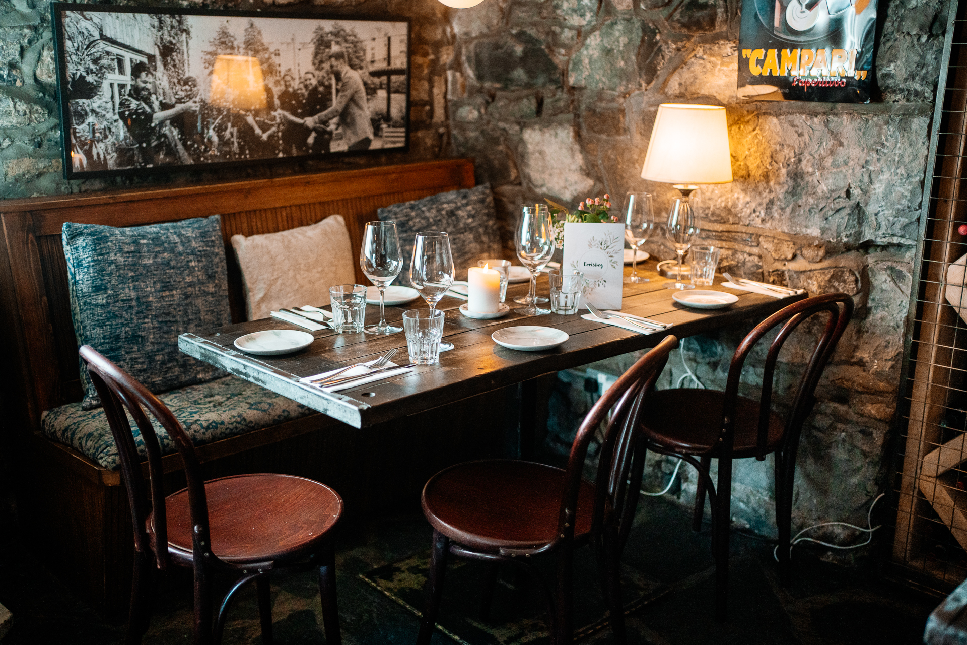 A dining table with a set of chairs and a lamp