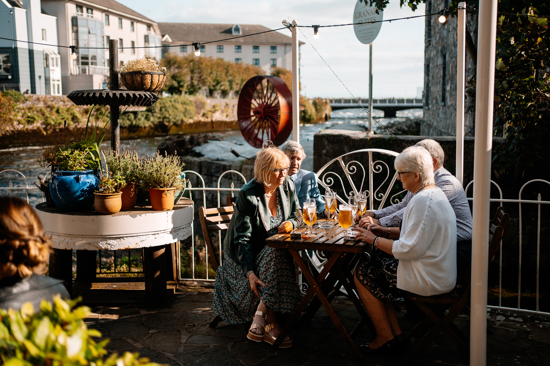 A group of people sitting at a table outside