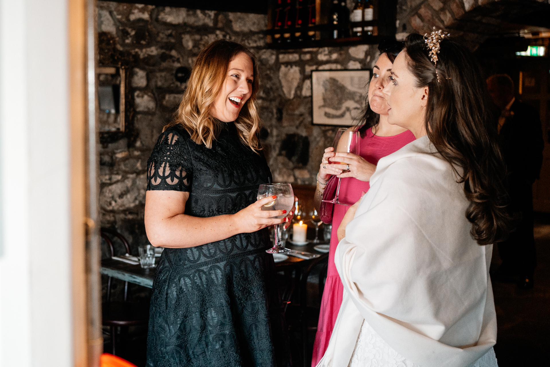 A couple of women holding wine glasses