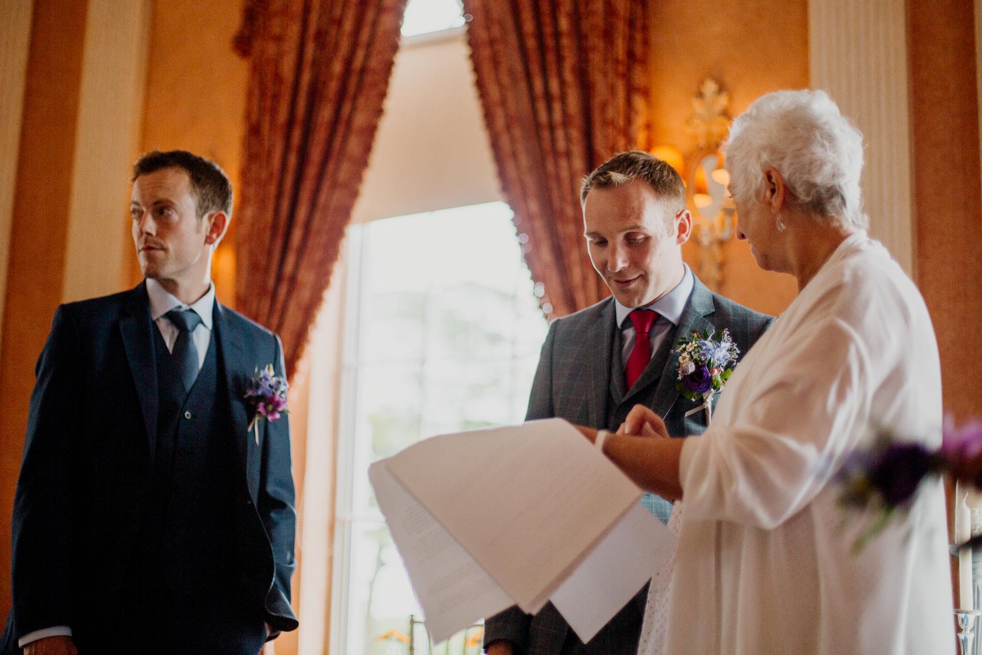 Bride and groom exchanging vows during their wedding ceremony at Glenlo Abbey Hotel, Galway.