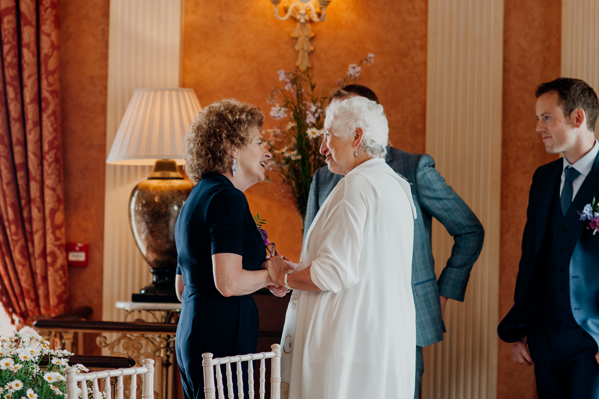 Bride and groom exchanging vows during their wedding ceremony at Glenlo Abbey Hotel, Galway.