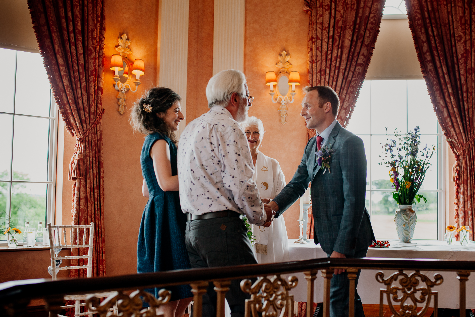 Bride and groom exchanging vows during their wedding ceremony at Glenlo Abbey Hotel, Galway.