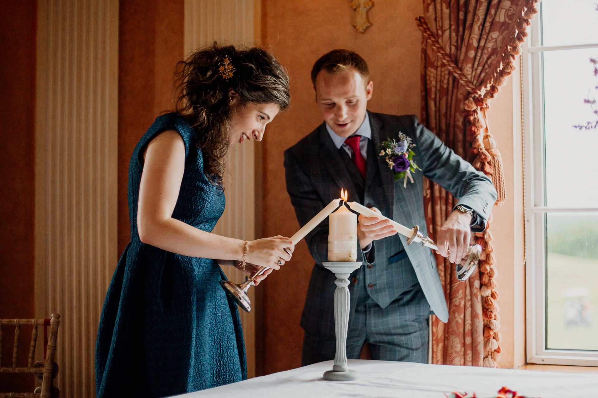 Bride and groom exchanging vows during their wedding ceremony at Glenlo Abbey Hotel, Galway.