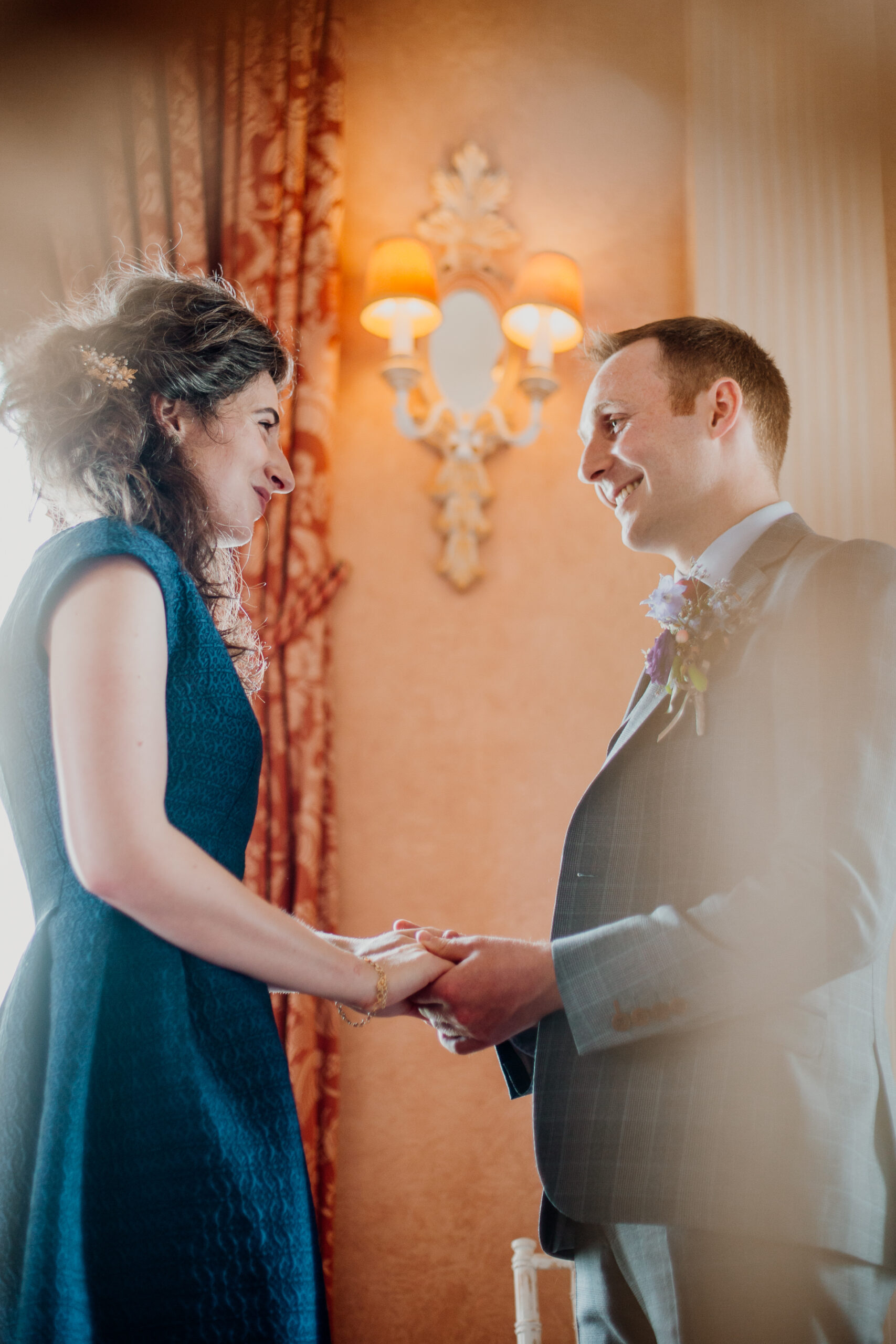 Bride and groom exchanging vows during their wedding ceremony at Glenlo Abbey Hotel, Galway.