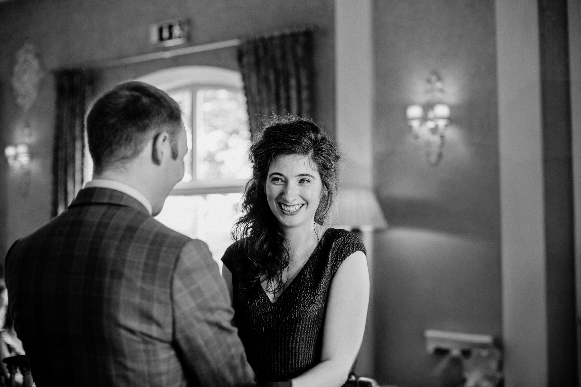 Bride and groom exchanging vows during their wedding ceremony at Glenlo Abbey Hotel, Galway.