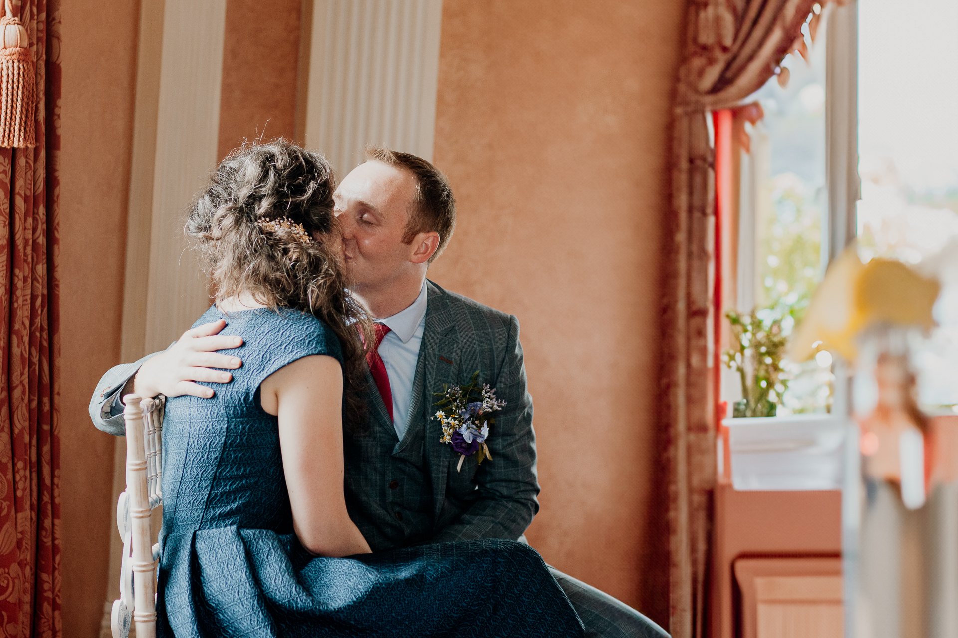 Bride and groom exchanging vows during their wedding ceremony at Glenlo Abbey Hotel, Galway.