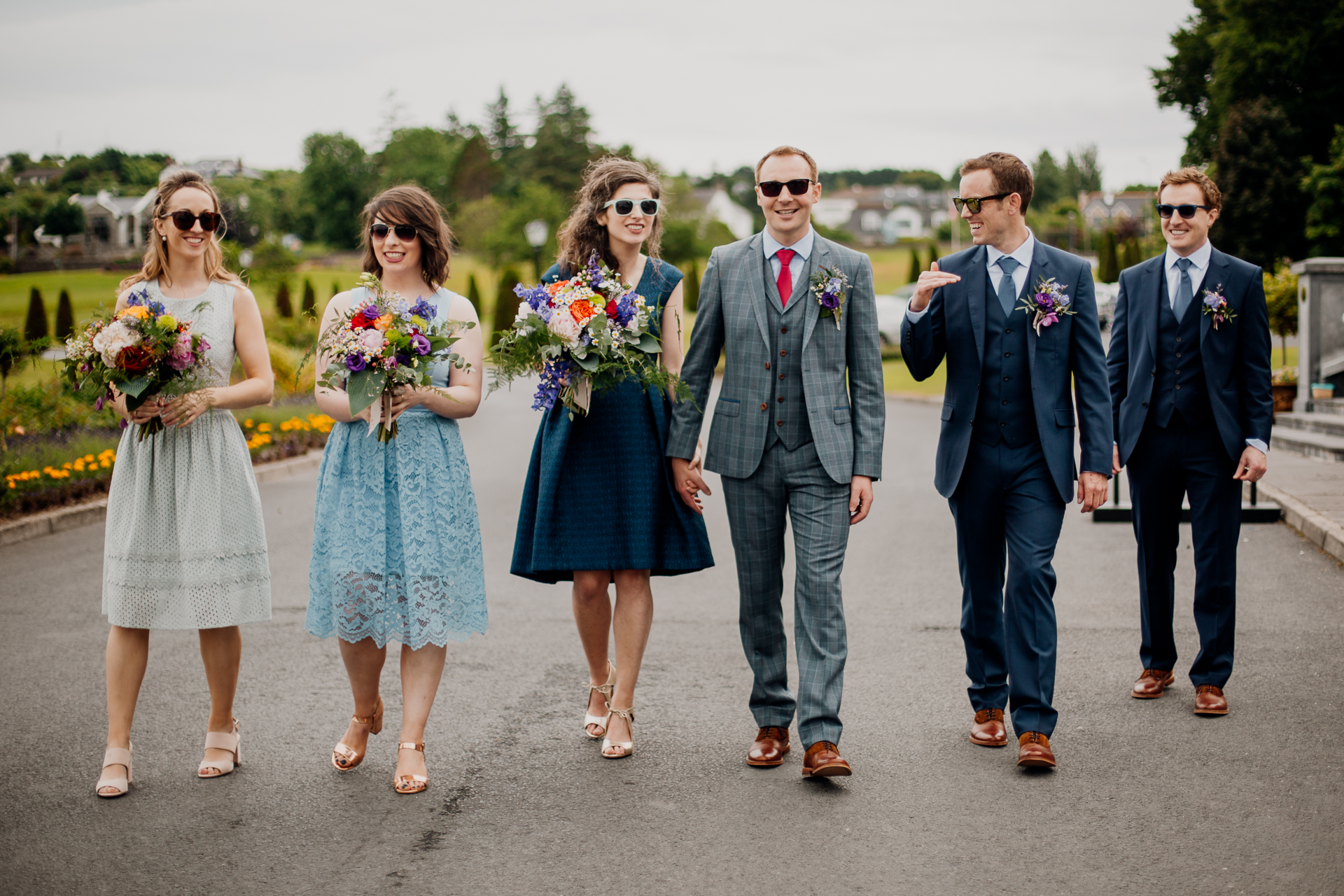 The bride and groom posing with their bridal party and family at Glenlo Abbey Hotel in Galway.