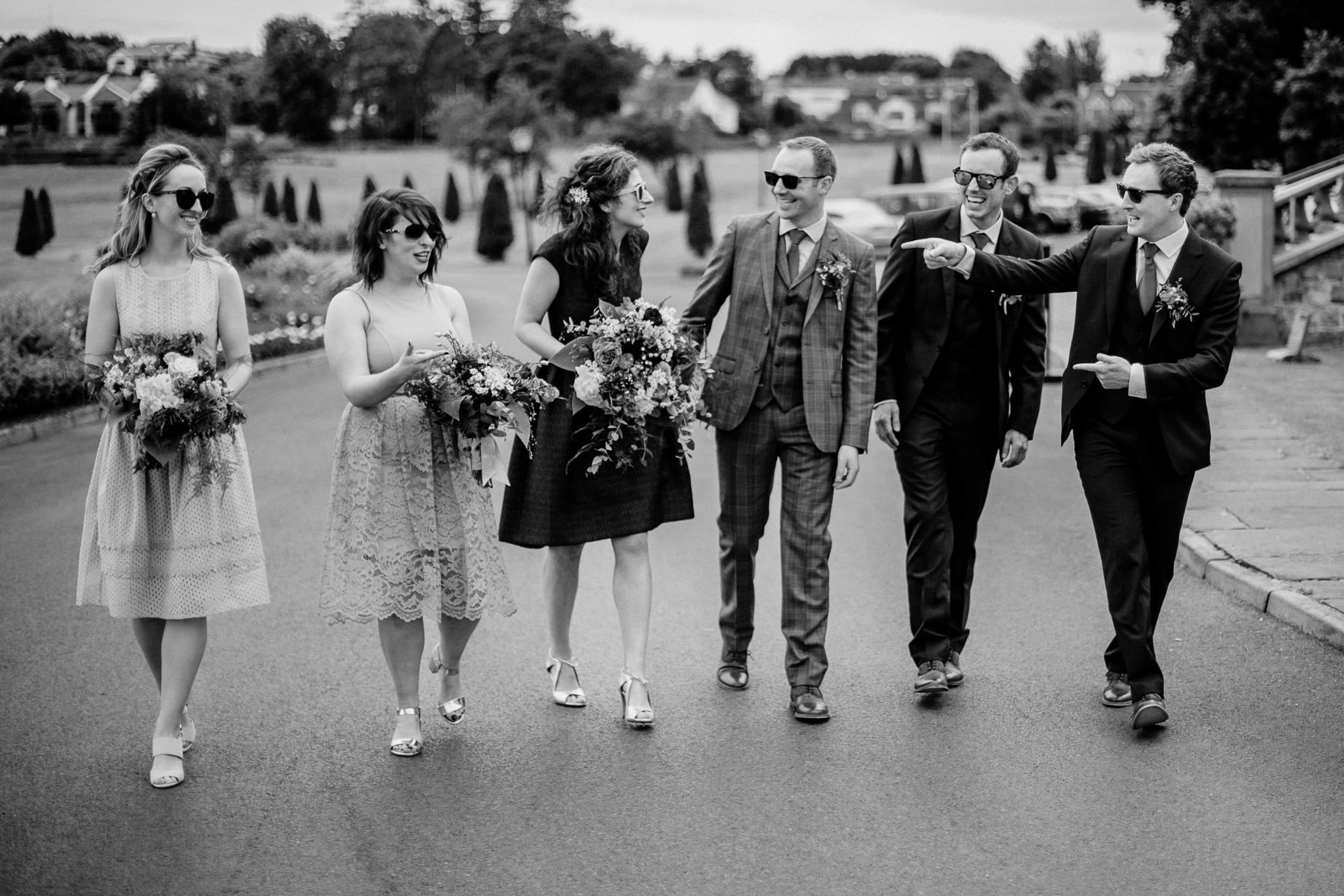 The bride and groom posing with their bridal party and family at Glenlo Abbey Hotel in Galway.