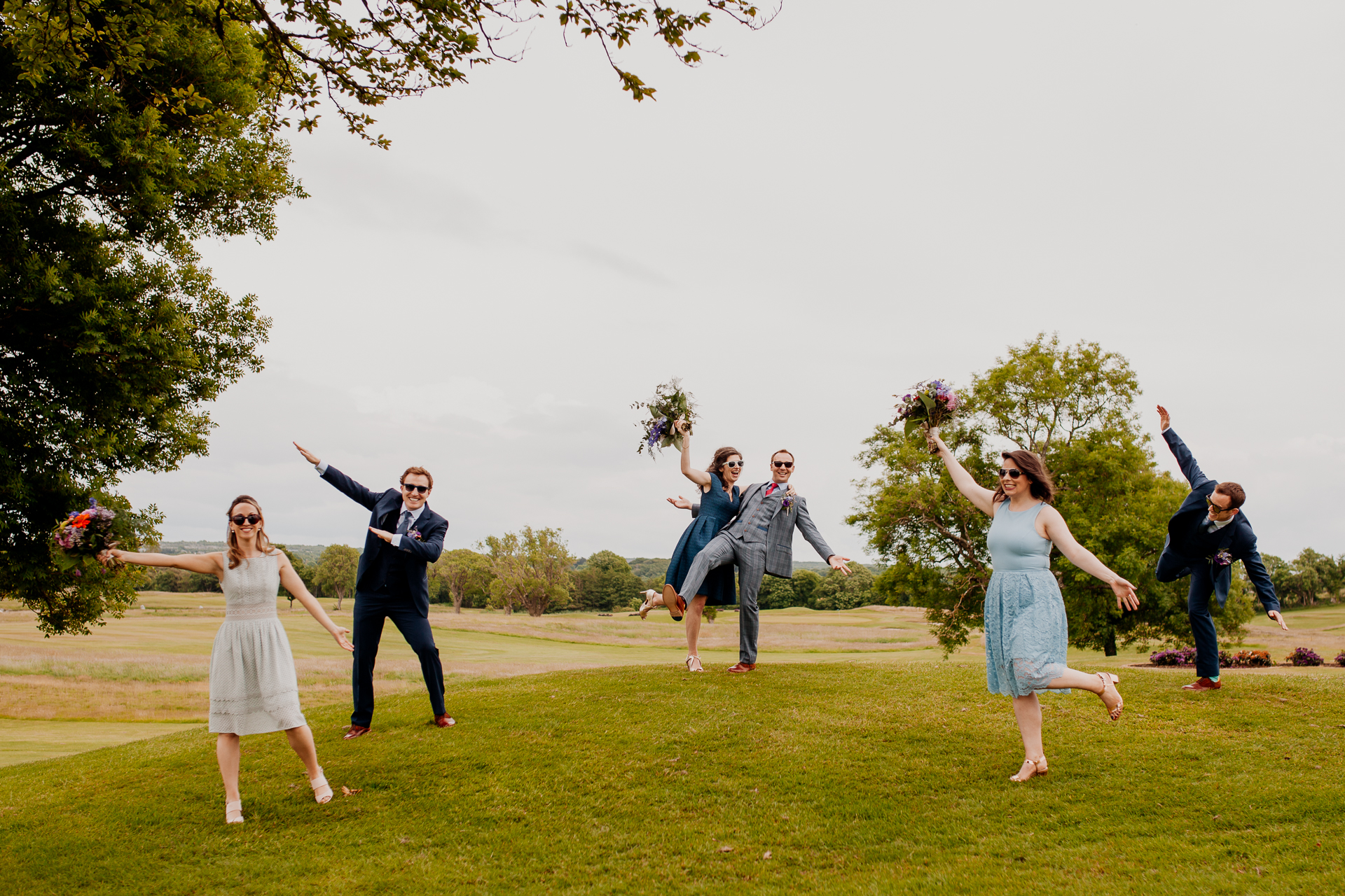 The bride and groom posing with their bridal party and family at Glenlo Abbey Hotel in Galway.