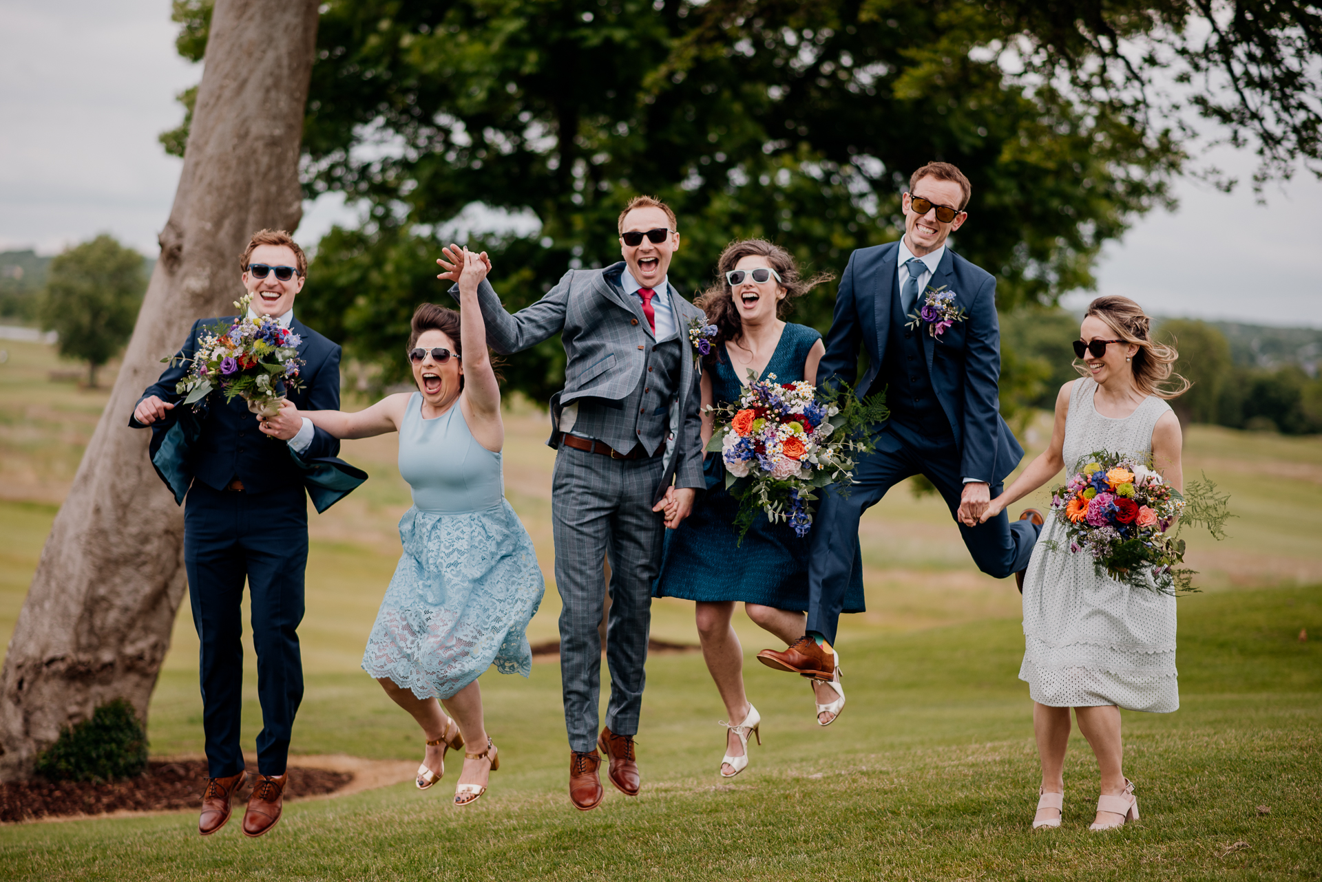 The bride and groom posing with their bridal party and family at Glenlo Abbey Hotel in Galway.