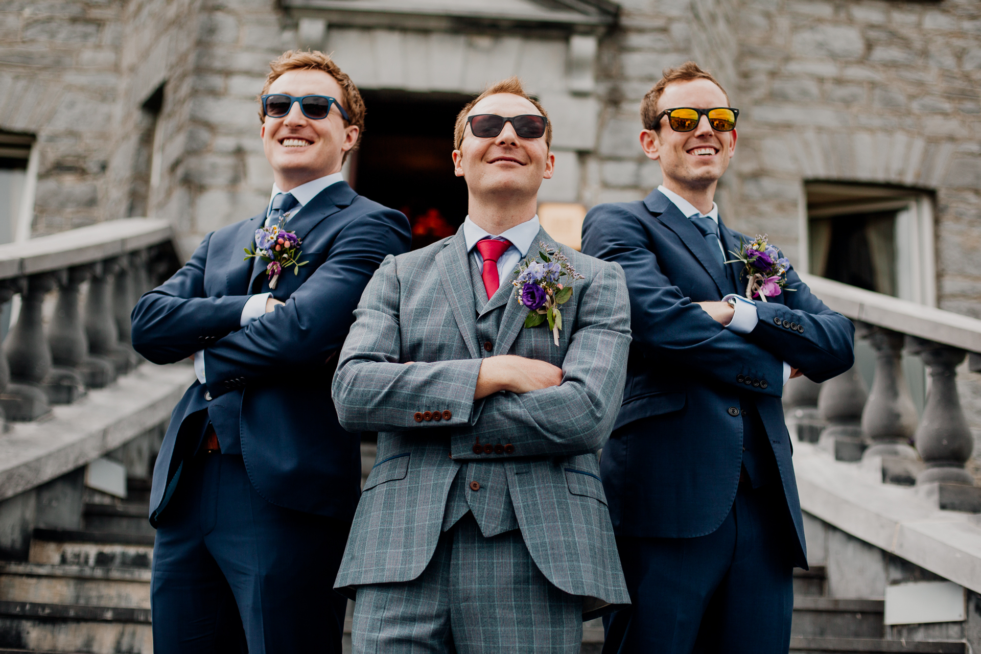 The bride and groom posing with their bridal party and family at Glenlo Abbey Hotel in Galway.