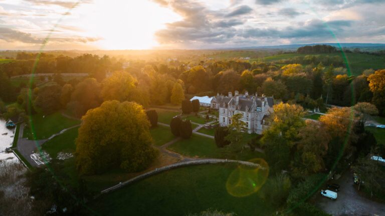 Castle Leslie Estate captured from above at golden hour, highlighting the wedding venue's stunning landscape.