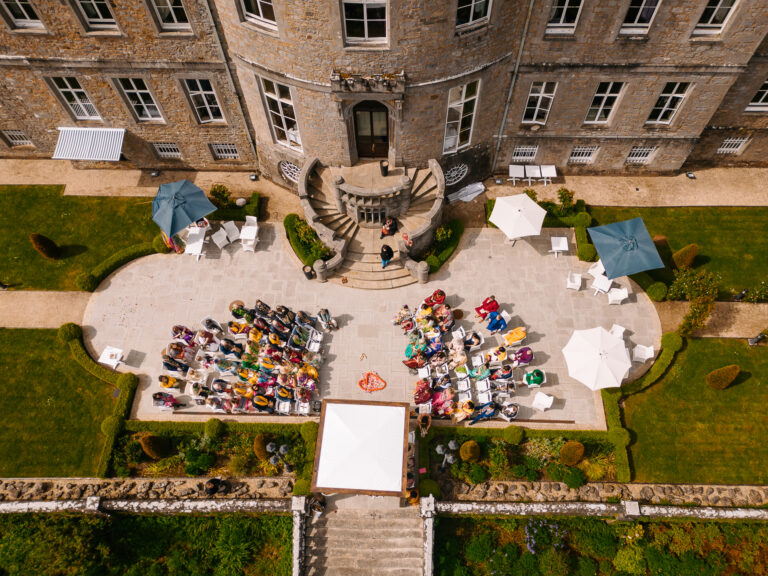Bird’s-eye view of an outdoor wedding reception in the courtyard of Markree Castle, surrounded by historic architecture and summer gardens