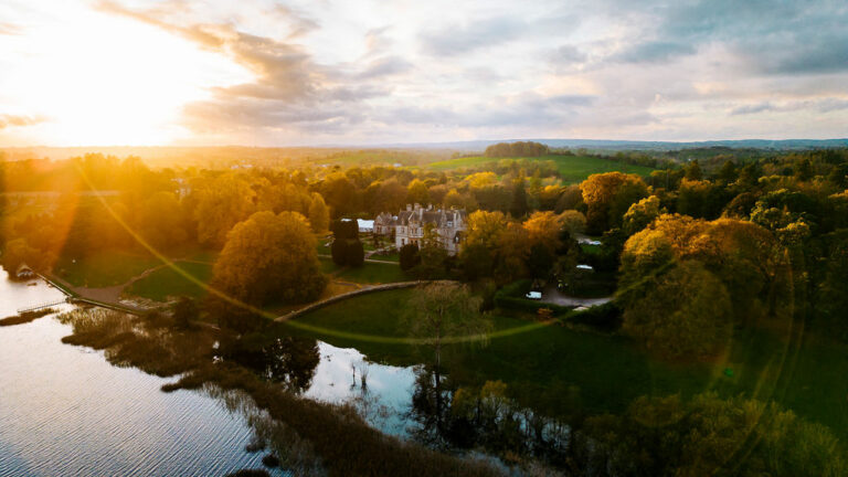 Scenic sunset view of Castle Leslie Estate with river and trees