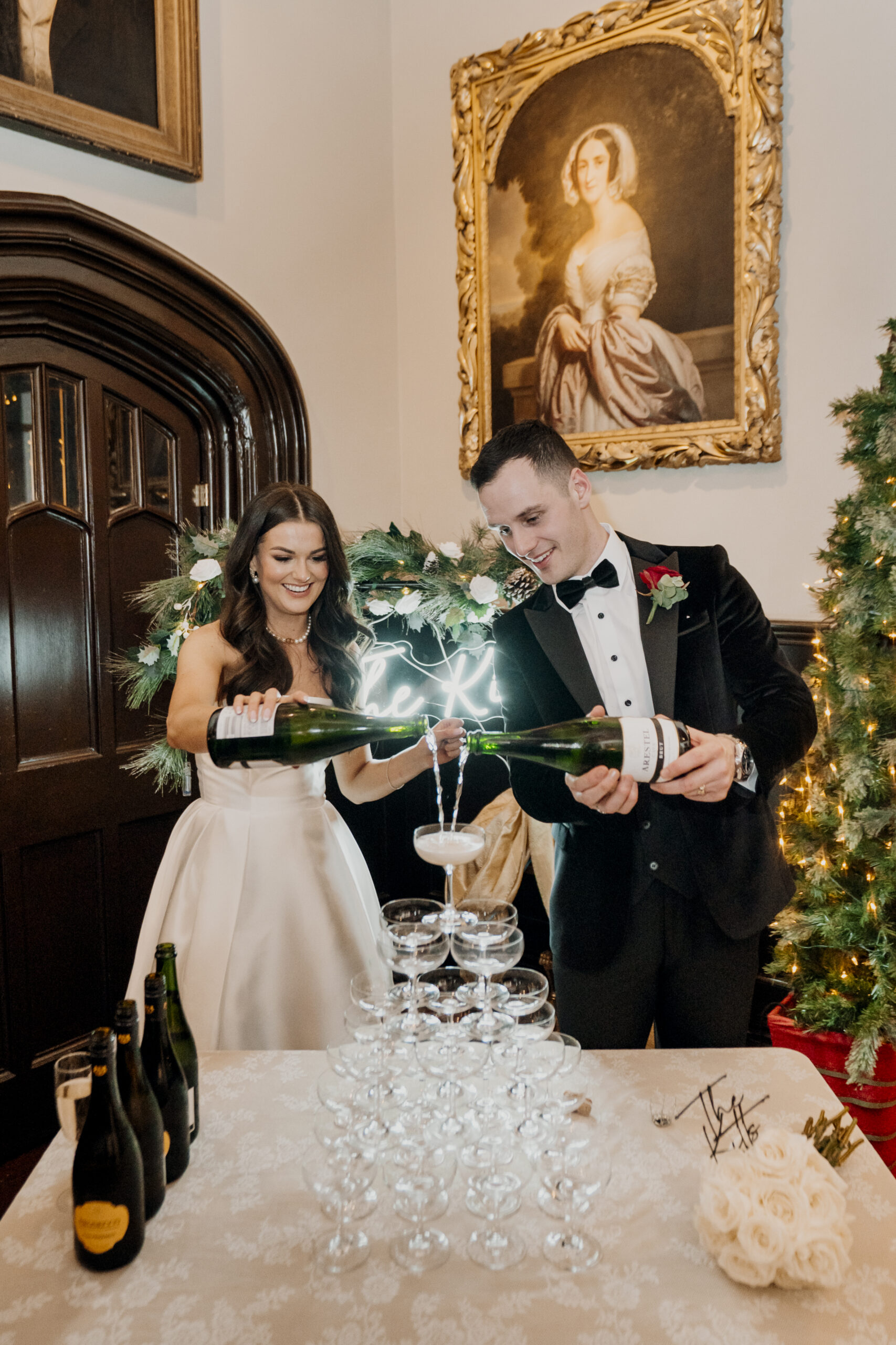 Bride and groom pouring champagne into a champagne tower at Markree Castle