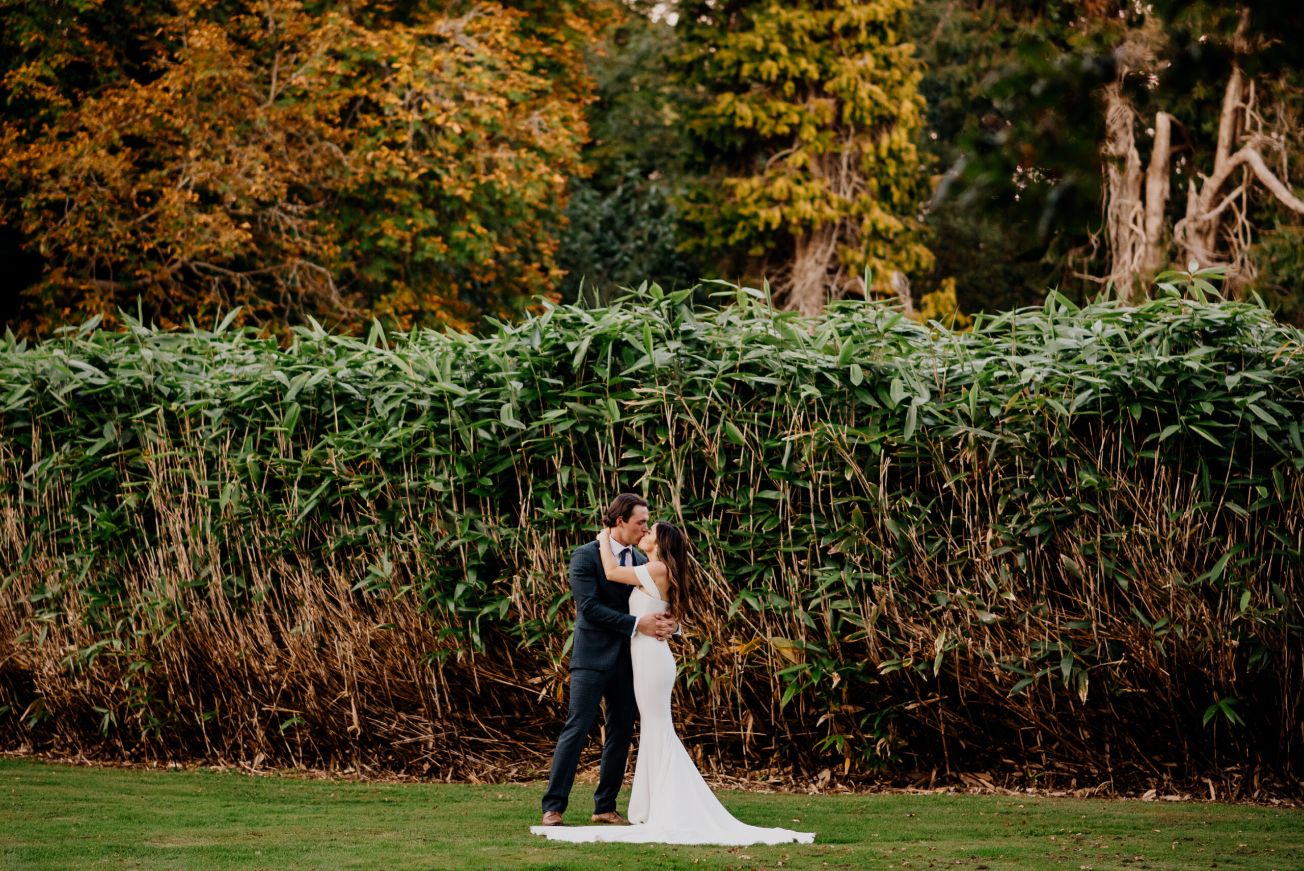 Bride and groom hugging in the garden at Markree Castle during an autumn wedding in Ireland – captured by a Destination Wedding Photographer.