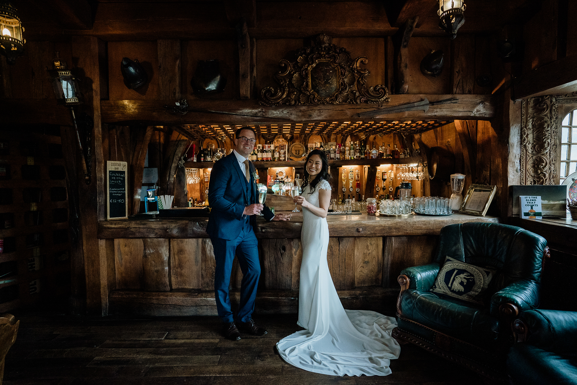 Bride and groom standing in Belleek Castle gin bar during wedding couple session