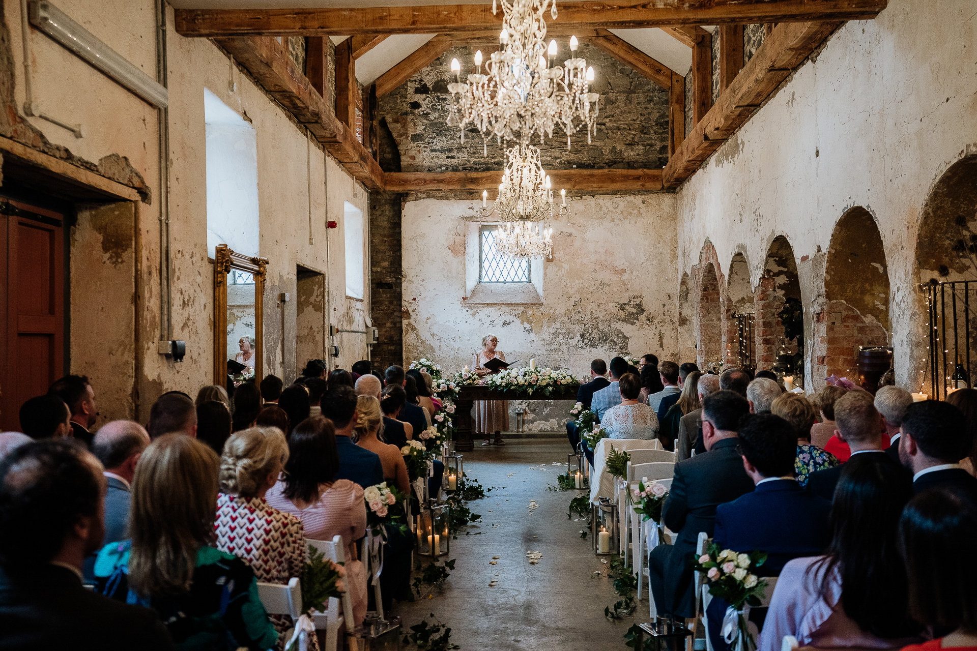 full room view of indoor wedding ceremony at belleek castle with guests seated