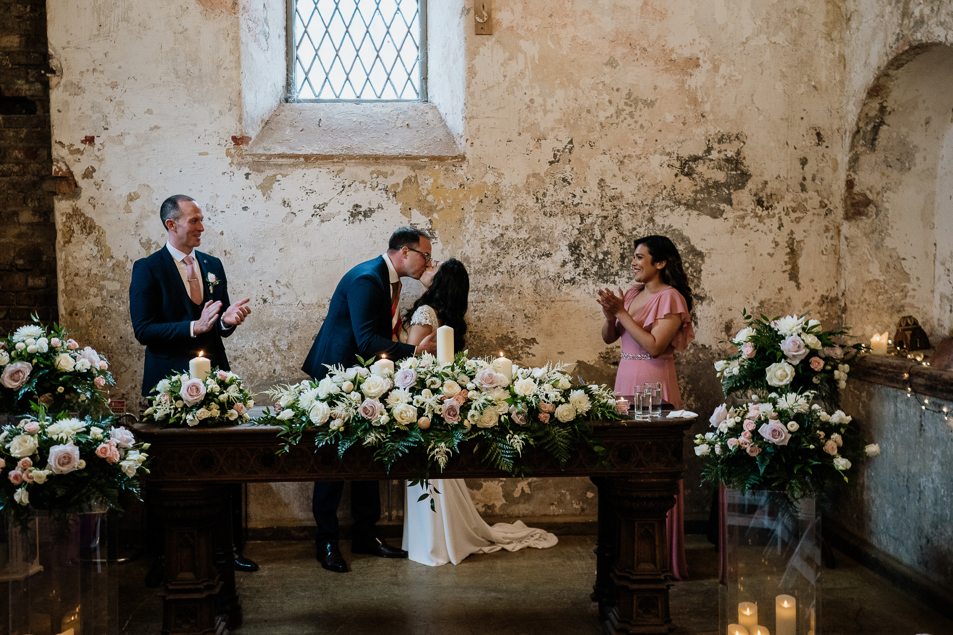 bride and groom signing the register during indoor wedding ceremony at belleek castle