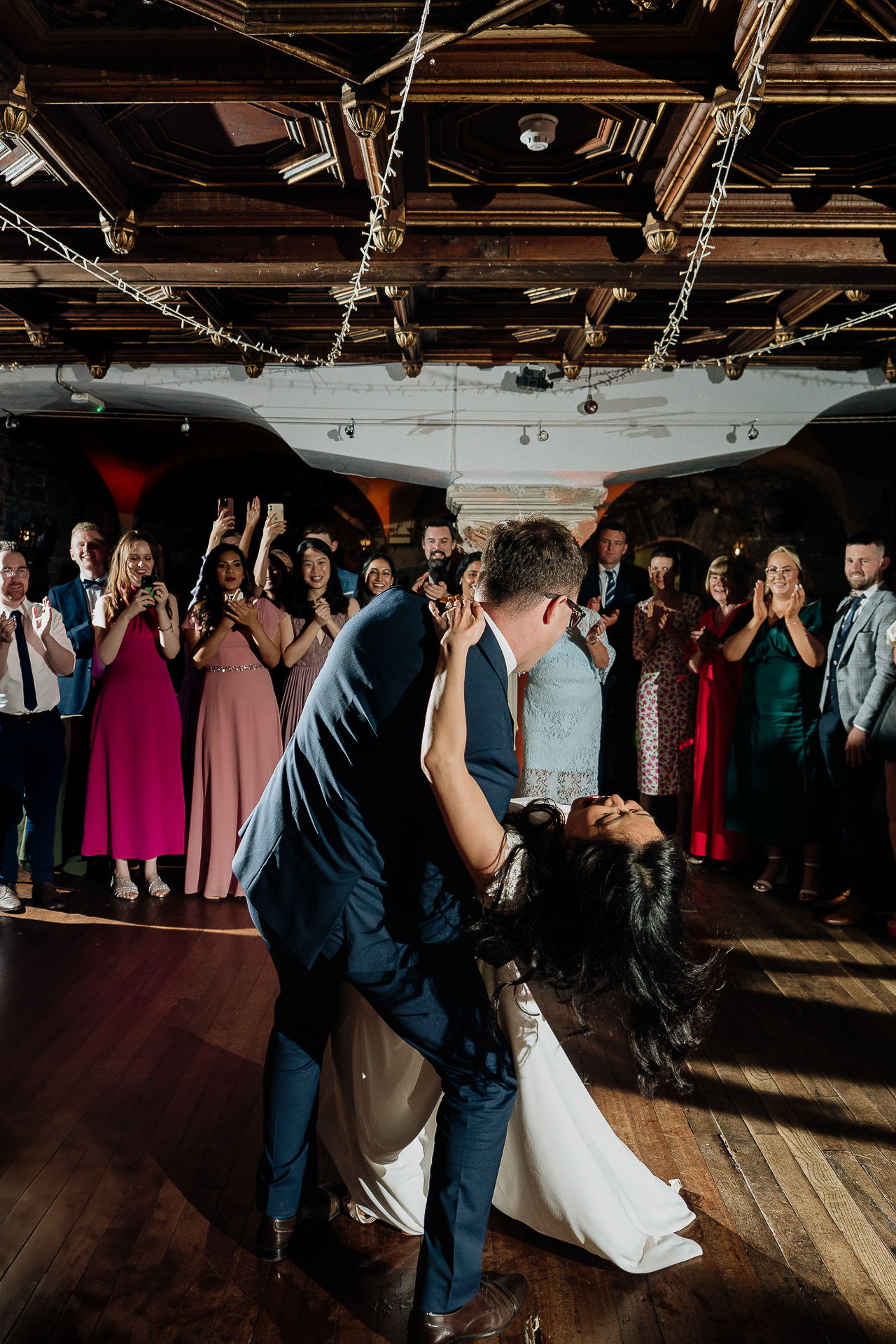A bride and groom performing a dramatic dip during their Belleek Castle Wedding first dance