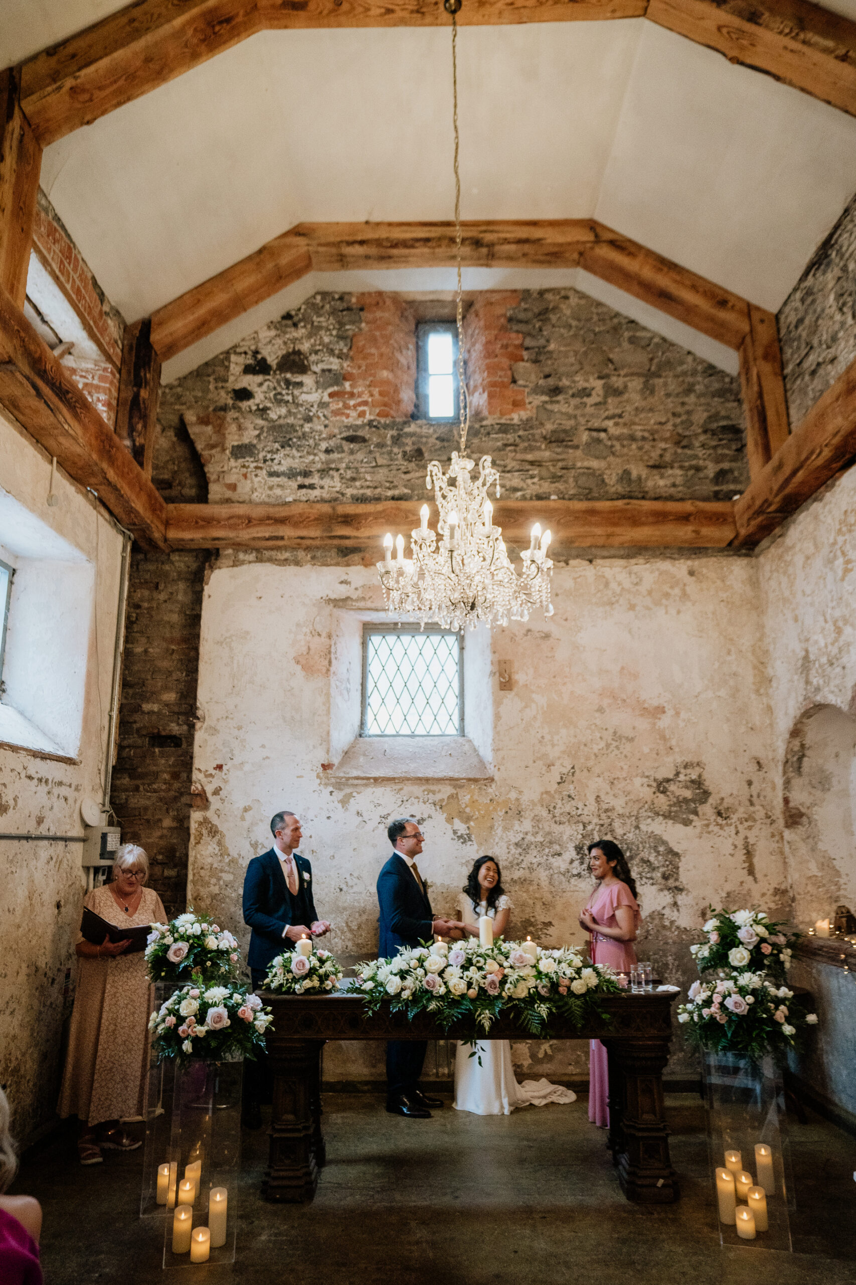 Bride and groom signing the wedding register inside the ceremony room at Belleek Castle