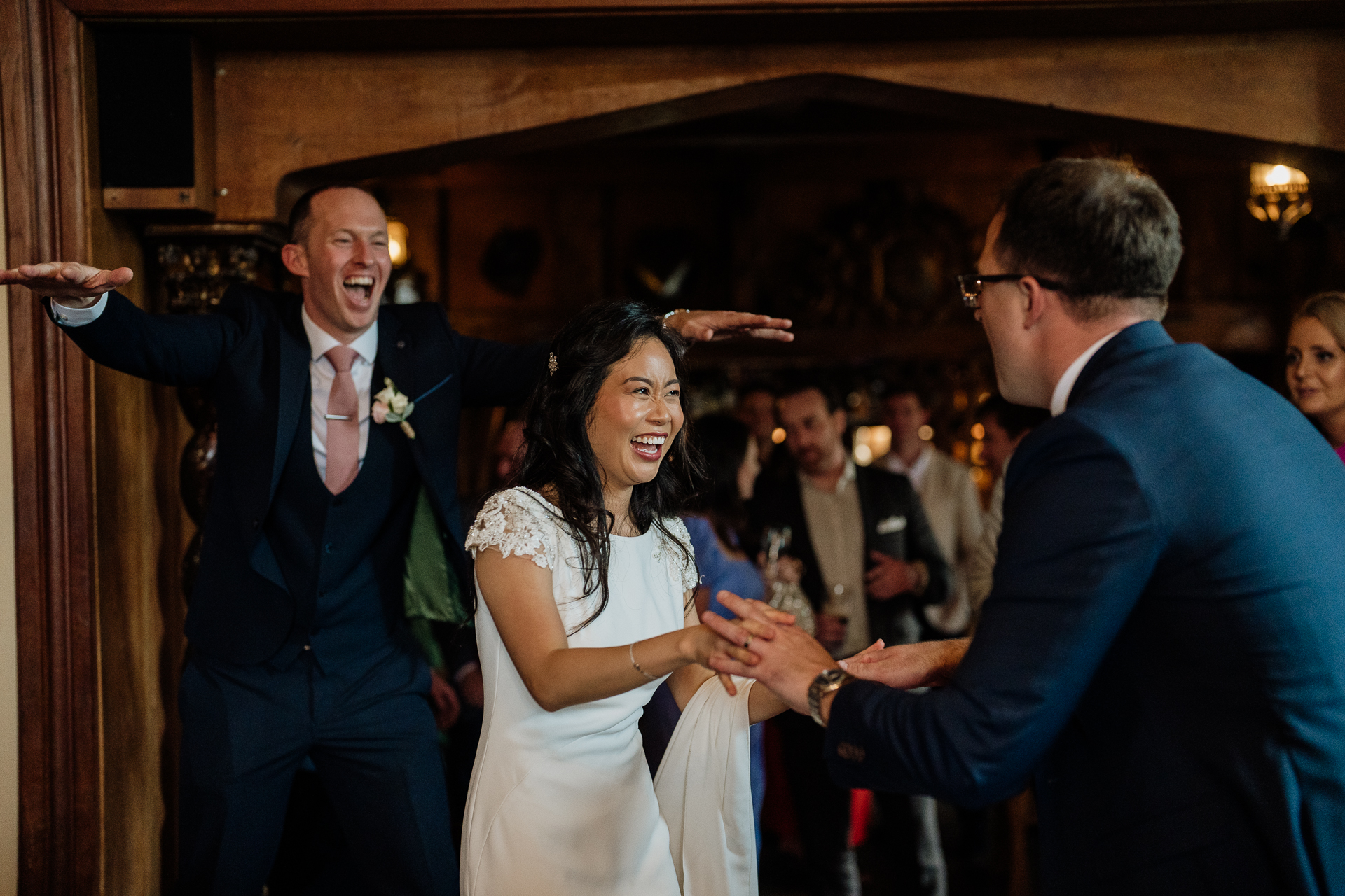 Guests cheering and clapping around the newlyweds during a wedding celebration