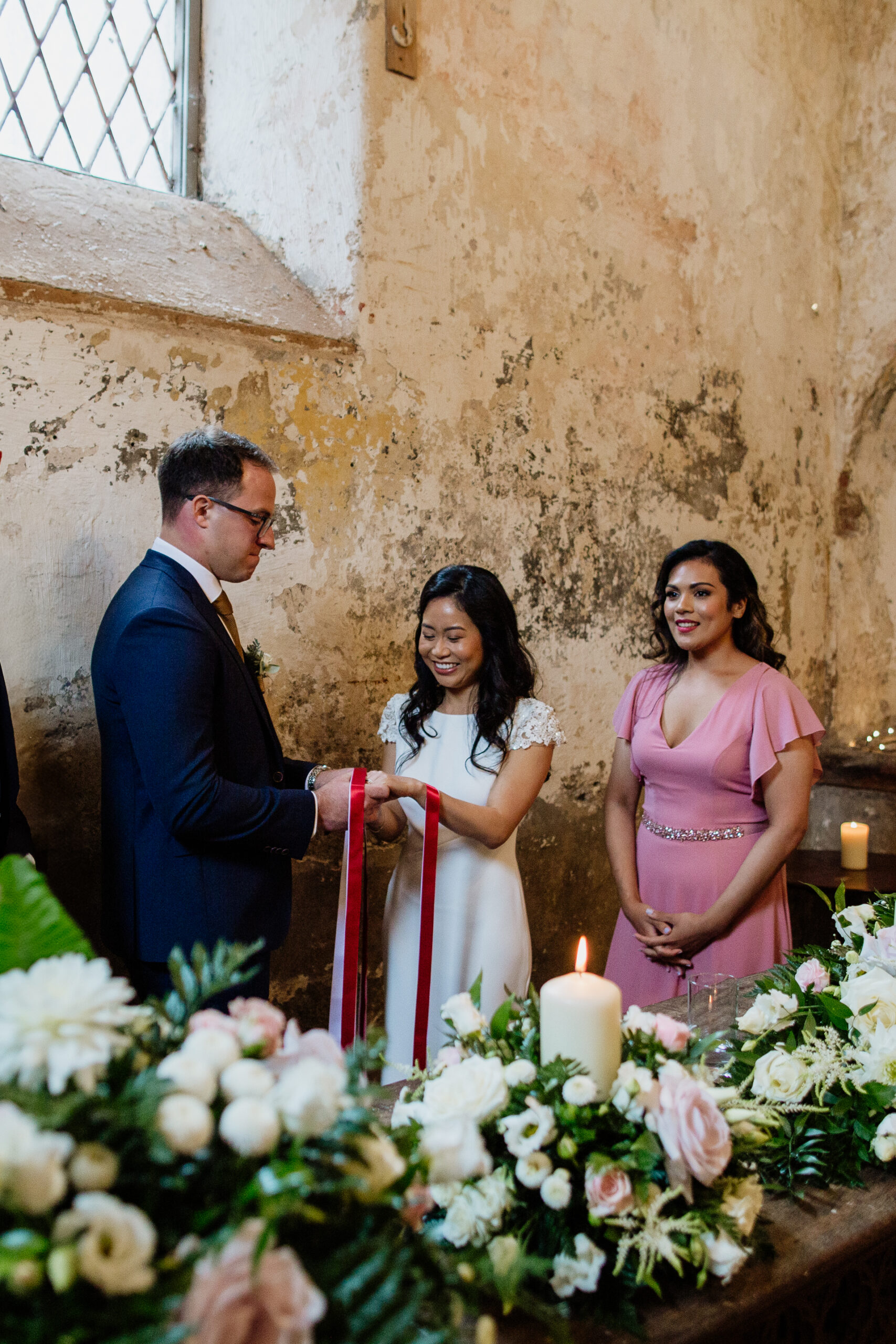 Bride and groom exchanging vows during indoor ceremony at Belleek Castle