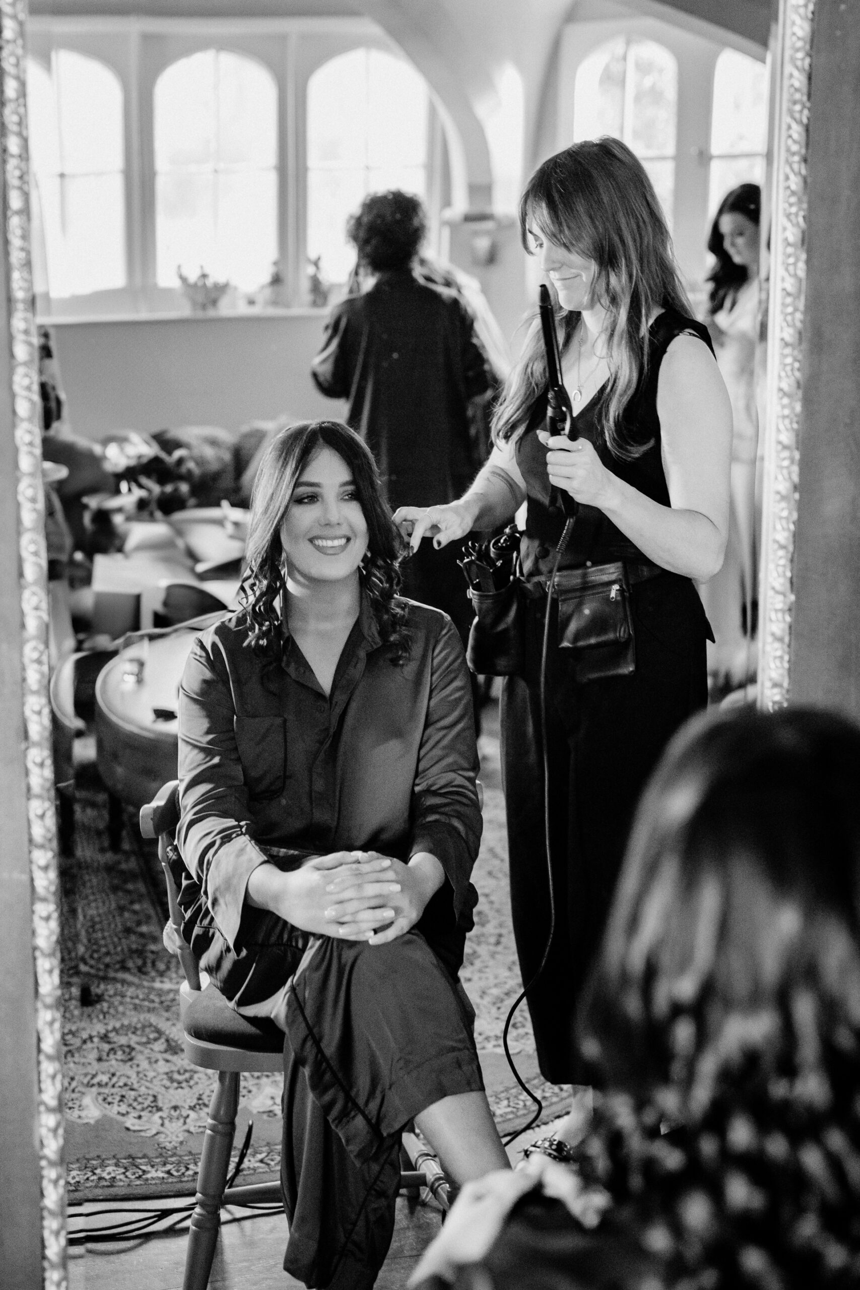 Black and white photo of bridesmaids getting ready in the Butler’s Kitchen at Markree Castle, sharing a candid morning moment.