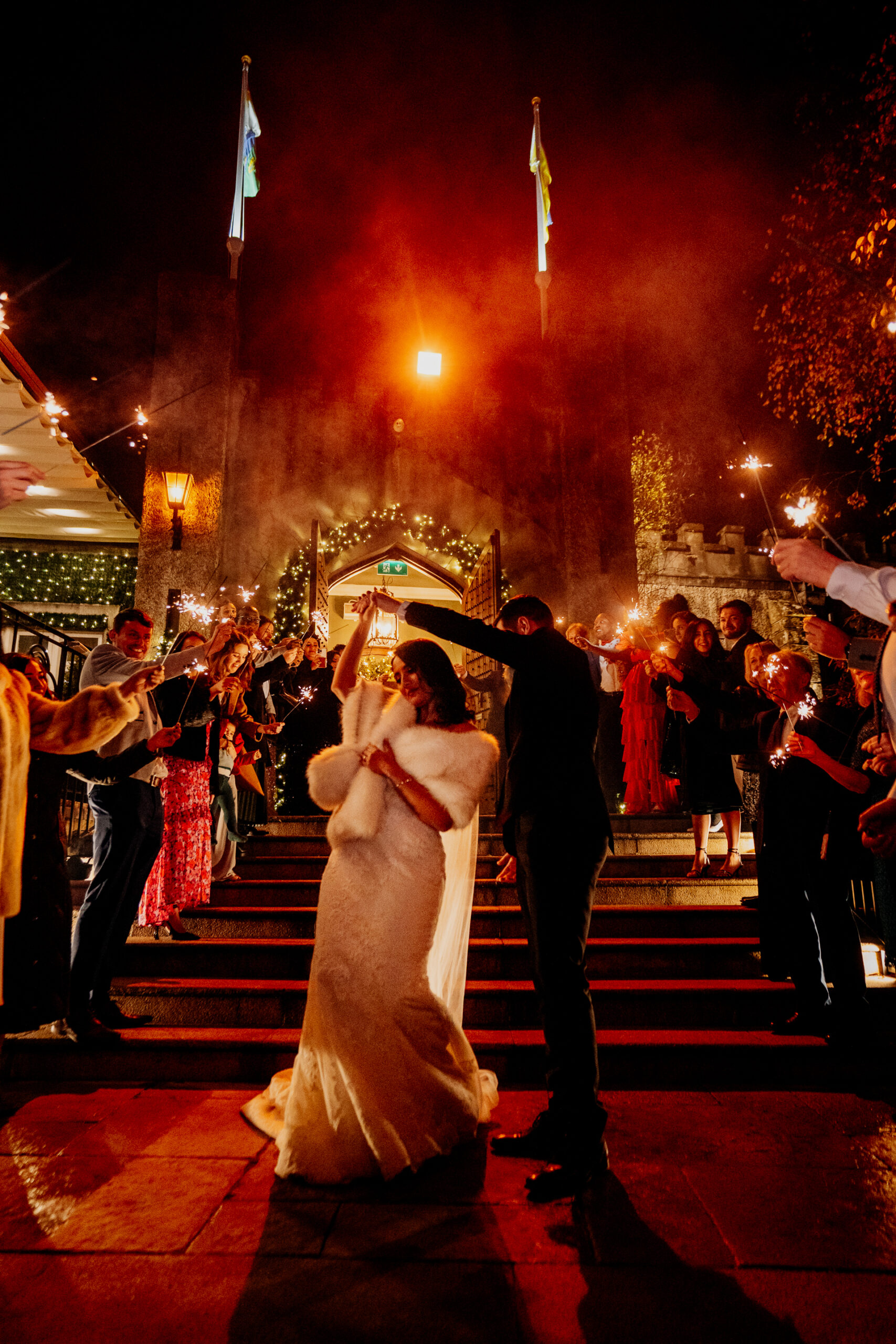Bride and groom share a romantic kiss during a sparkler exit at Cabra Castle Wedding, captured by a Dublin Wedding Photographer